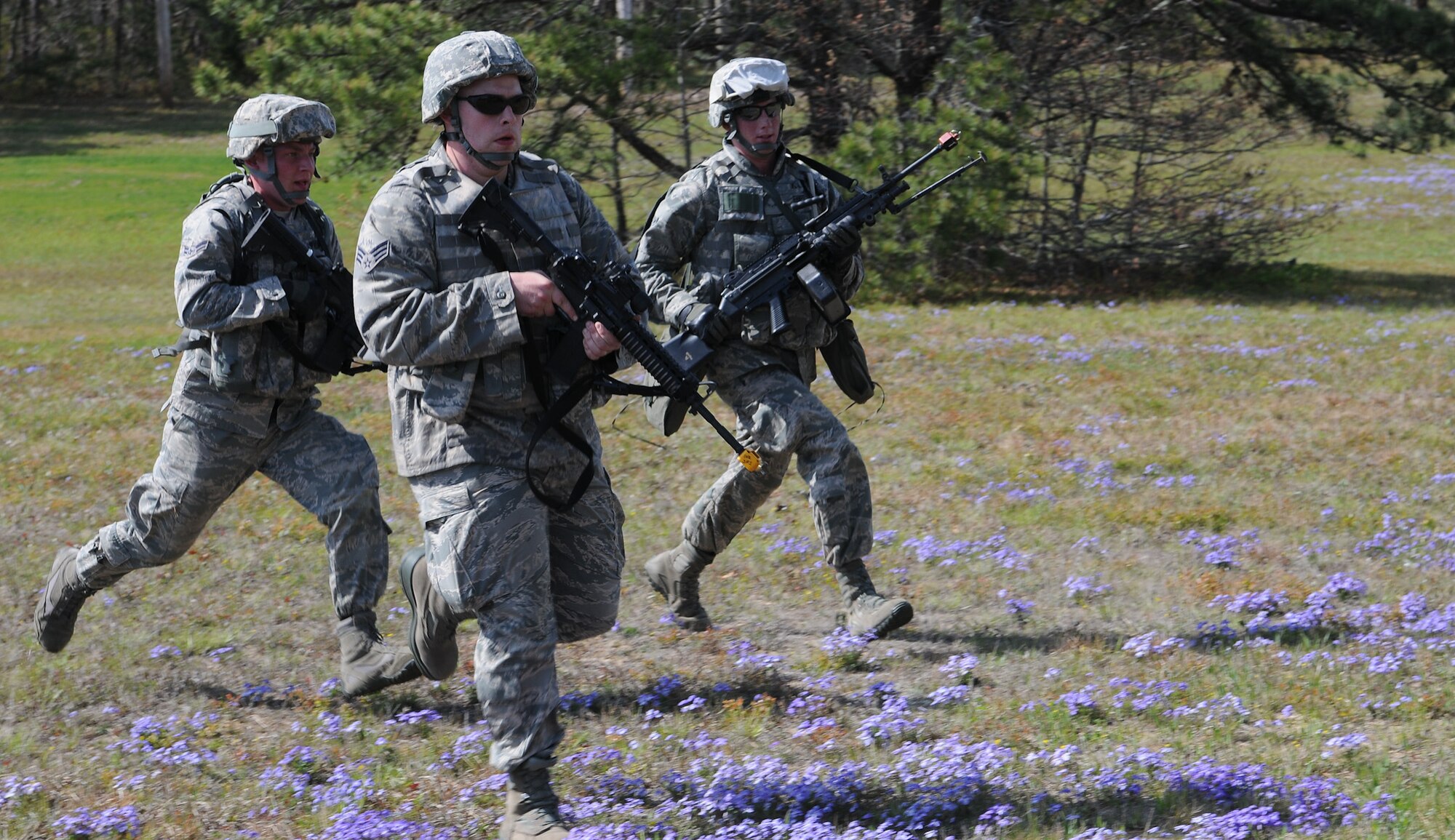 102nd Security Forces Squadron members A1C Michael Whiting, left, SrA Joseph Perella, center, and A1C Justin Ennes, right, sprint across a field to engage opposition forces during a dismounted patrol exercise on Otis Air National Guard Base May 7, 2012. During the dismounted patrol portion of their training, the 102 SFS defenders were tasked with locating and navigating their way to five checkpoints on Otis ANGB while moving tactically in formations.  The 102 SFS defenders spent the day honing their skills in areas such as convoy operations and dismounted patrol procedures in order to keep their proficiency at a high level. (U.S. Air Force photo/ Senior Airman Patrick McKenna)