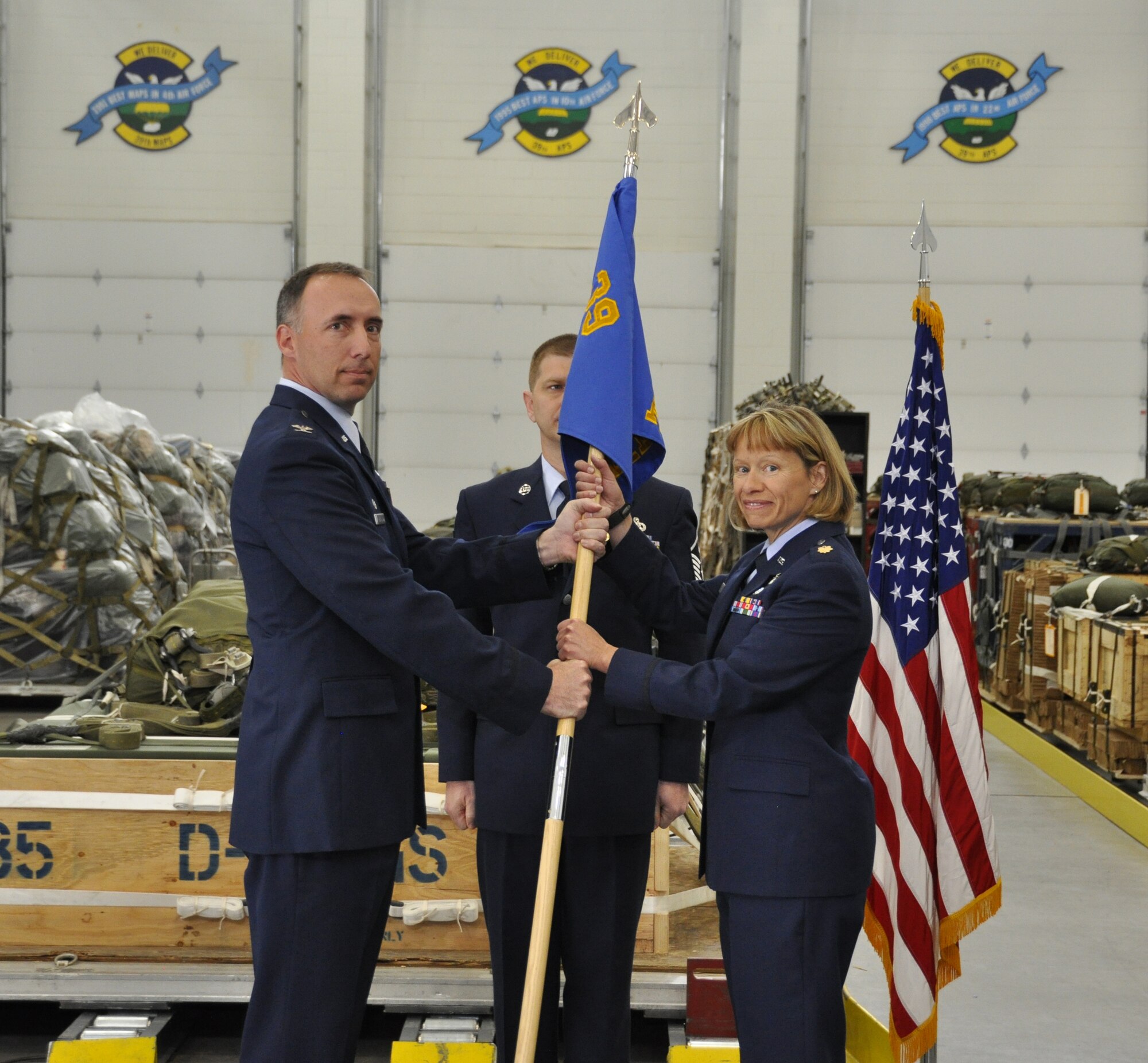 Major Deborah Ings, on right, assumed command of the 39th Aerial Port Squadron during a change of command ceremony held May 6 here. On left, Col. Michael Burns, 302nd Mission Support Group Commander, passes the 39th APS guidon to Ings. (U.S. Air Force photo/Tech. Sgt. Peter Dean) 