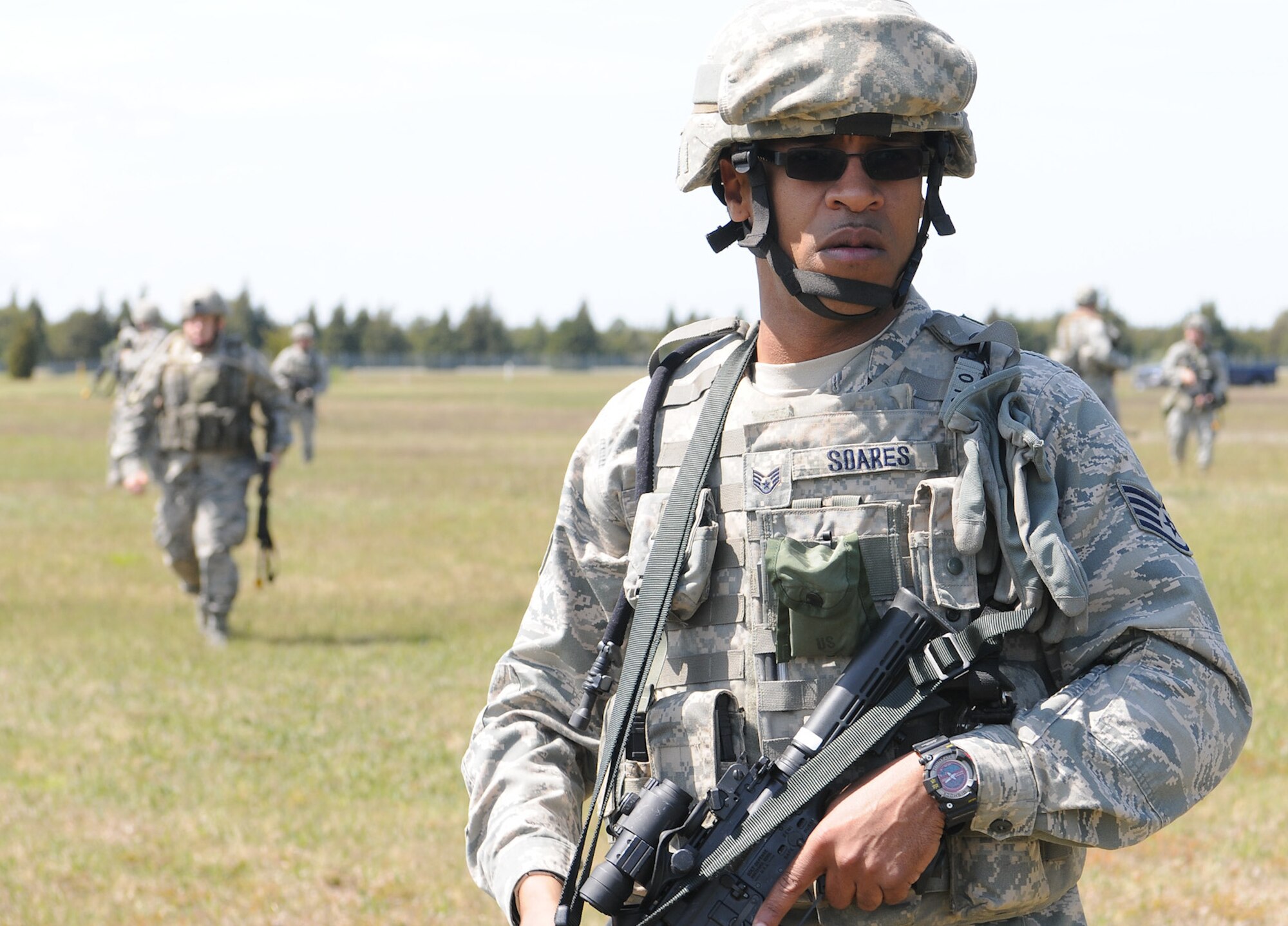 Staff Sgt. Keith Soares, 102nd Security Forces Squadron, scans his sector for potential threats as his fellow squad members follow behind him in tactical formation during the dismounted patrol portion of their annual combat readiness task training on Otis Air National Guard Base May 7, 2012. The 102 SFS defenders were tasked with locating and navigating their way to five checkpoints on Otis ANGB while moving tactically in formations.  The 102 SFS defenders spent the day honing their skills in areas such as convoy operations and dismounted patrol procedures in order to keep their proficiency at a high level. (U.S. Air Force photo/ Senior Airman Patrick McKenna)