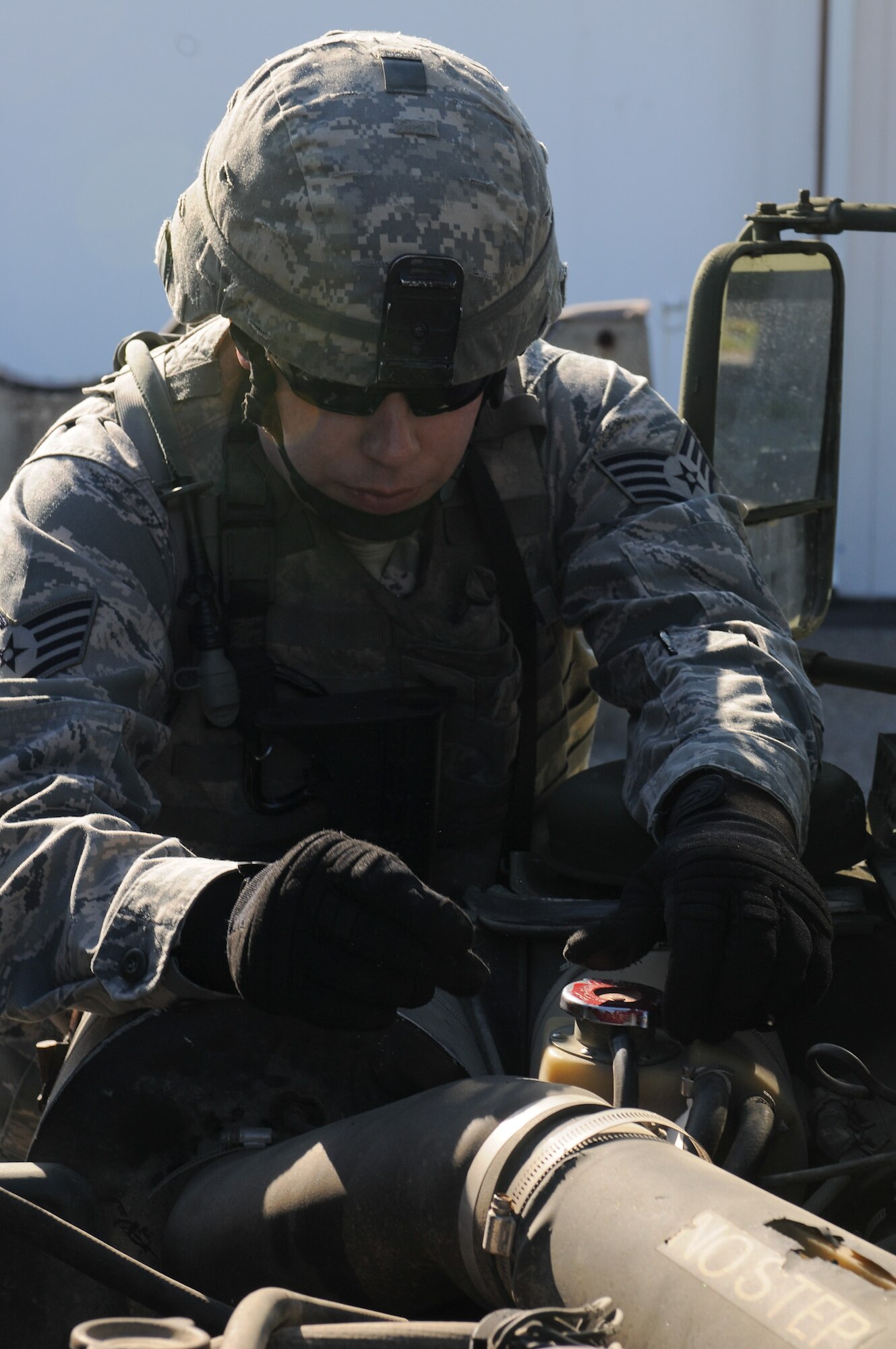 Staff Sgt. Michael Moynihan, 102nd Security Forces Squadron, performs a vehicle inspection prior to his squad taking part in convoy operations annual training on Otis Air National Guard Base May 7, 2012. Moynihan checked his vehicle’s exterior as well as its engine to ensure it was in satisfactory condition to complete their assigned mission. The 102 SFS defenders spent the day honing their skills in areas such as convoy operations and dismounted patrol procedures in order to keep their proficiency at a high level. (U.S. Air Force photo/ Senior Airman Patrick McKenna)