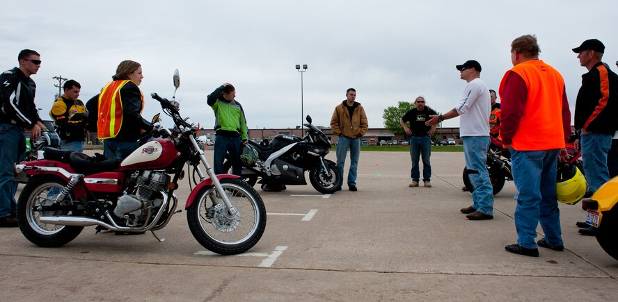 Airmen listen to instruction and advice from Tech. Sgt. Scott Shipman, 28th Maintenance Squadron crew chief, after successfully completing a portion of the Motorcycle Safety Foundation Course in front of the Pride Hangar on Ellsworth Air Force Base, S.D., May 3, 2012. The courses are designed to prevent safety hazards and reduce risks by teaching Airmen the correct way to operate a motorcycle. (U.S. Air Force photo by Airman 1st Class Kate Thornton/Released)
