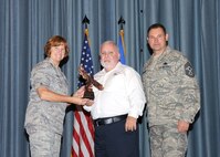 Col. Kimberly Toney (left), Air Force Recruiting Service vice commander, and Chief Master Sgt. William Cavenaugh (left), AFRS chief, present the Supervisor Civilian Category I of the Quarter Award to Michael Howell, 12th Flying Training Wing. The first-quarter Joint Base San Antonio-Randolph award winners were recognized during an awards ceremony at the base theater May 4. (U.S. Air Force photo by Melissa Peterson)