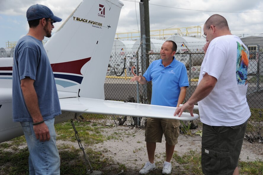 Master Sgt. Thomas Black, a reservist with 63rd Air Refueling Squadron, instructs two of his students at a hanger in Clearwater, Fla., May 7, 2012.  Sergeant Black is a boom operator on the KC-135 Stratotanker, but his aviation knowledge extends far beyond that.  He is also a former Air Force maintainer, a civilian pilot and the owner of a business that offers various services from pilot and maintenance instruction to airplane repair.  He said flying has always been a passion of his, one that the Air Force and its educational benefits have helped him pursue. 