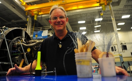 David Geyer uses a flashlight, mirrors and identification tags to inspect an F-117 engine at Joint Base Charleston – Air Base May 3. Geyer works with the aircraft maintenance technicians to make sure every issue on the engine is corrected. Geyer is a United Airlines F-117 engine inspector. (U.S. Air Force photo/Airman 1st Class Dennis Sloan)