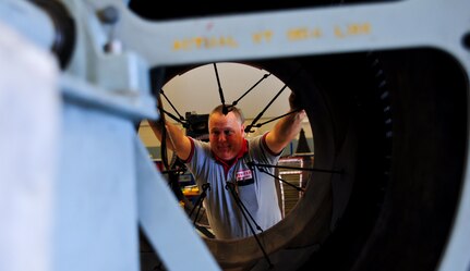 Danny Page assembles the core thrust reverser on an F-117 engine at Joint Base Charleston – Air Base May 3. Page served in the Air Force at Dover Air Force Base, Del., as a crew chief on a C-5 Galaxy. The F-117 engine is used on the C-17 Globemaster III. Page is a United Airlines aircraft maintenance technician. (U.S. Air Force photo/Airman 1st Class Dennis Sloan)