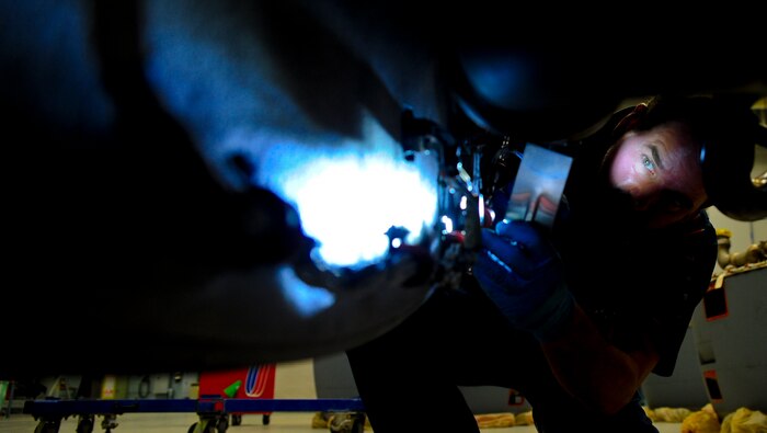 Jerry Zuk uses a flashlight and a mirror to inspect the underside of an F-117 engine at Joint Base Charleston – Air Base May 3. Zuk spends several hours looking at everything from metal pipes, steel fan blades to electrical wires and insulation to make sure the engine meets all of its specifications. The engine will be used on a C-17 Globemaster III once it passes inspection, testing and is certified. Zuk is a United Airlines F-117 engine inspector. Zuk is a United Airlines F-117 engine inspector. (U.S. Air Force photo/Airman 1st Class Dennis Sloan)