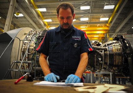 Jerry Zuk reviews an inspection checklist after removing several tags from an F-117 engine at Joint Base Charleston – Air Base May 3. Zuk, a retired Air Force crew chief, inspects the engine several times throughout the build-up process. Once the engine is inspected, tested and certified, it is installed on a C-17 Globemaster III. Zuk is a United Airlines F-117 engine inspector. (U.S. Air Force photo/Airman 1st Class Dennis Sloan)