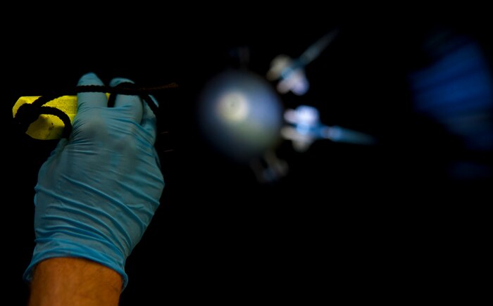 Jerry Zuk uses a flashlight to illuminate specific areas of the core thrust reverser at Joint Base Charleston – Air Base May 3 during the final inspection before it is presented to a Boeing inspector. Zuk served in the Air Force for seven years at Dover Air Force Base, Del., where he was a crew chief on a C-5 Galaxy. His current position as an inspector requires him to check every inch of the F-117 engine. Zuk is a United Airlines F-117 engine inspector.  (U.S. Air Force photo/Airman 1st Class Dennis Sloan)