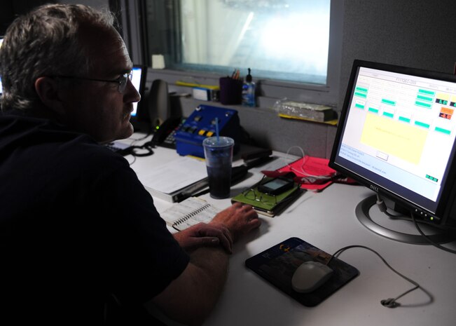 Corey Seeber monitors valve checks on a C-17 Globemaster III engine test run at the engine test cell at Joint Base Charleston – Air Base May 3. The all-civilian engine shop installs, inspects and repairs five to six engines a month. Seeber is an aviation maintenance technician with United Airlines. (U.S. Air Force photo/Staff Sergeant Katie Gieratz)