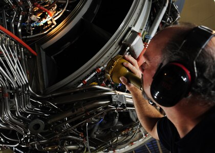 Tim Gorman inspects a C-17 Globemaster III engine for fuel or oil leaks at the engine test cell at Joint Base Charleston – Air Base May 3. The all-civilian engine shop installs, inspects and repairs five to six engines a month. Goreman is an aviation maintenance technician with United Airlines. (U.S. Air Force photo/Staff Sergeant Katie Gieratz)