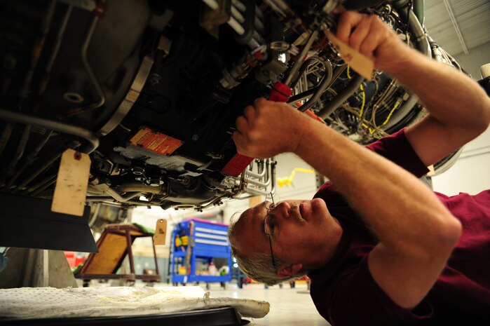 Corey Seeber repairs fireloop clamps on a C-17 Globemaster III engine at the Joint Base Charleston – Air Base engine shop May 2. The fireloop is used for warning pilots if there is a fire in an engine. Seeber is an aviation maintenance technician with United Airlines. (U.S. Air Force photo/Staff Sergeant Katie Gieratz)