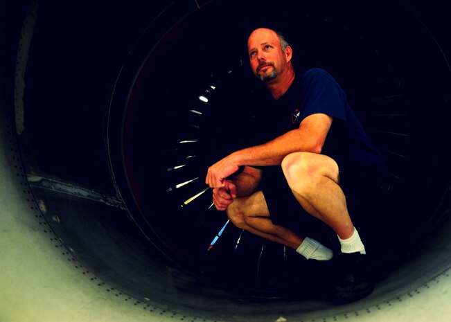 Tim Gorman stops for a photo in a C-17 Globemaster III engine inlet at the Joint Base Charleston – Air Base C-17 engine shop May 2. Goreman is an aviation maintenance technician with United Airlines. (U.S. Air Force photo/Staff Sergeant Katie Gieratz)