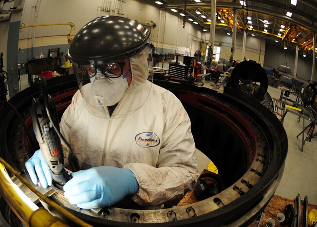 Steve Cadmus uses a ball rotary file to modify a scallop ring so heat expansion will not cause cracking at the Joint Base Charleston – Air Base engine shop May 3. The all-civilian engine shop installs, inspects and repairs five to six engines a month. Cadmus is an aviation maintenance technician with United Airlines. (U.S. Air Force photo/Staff Sgt. Katie Gieratz)