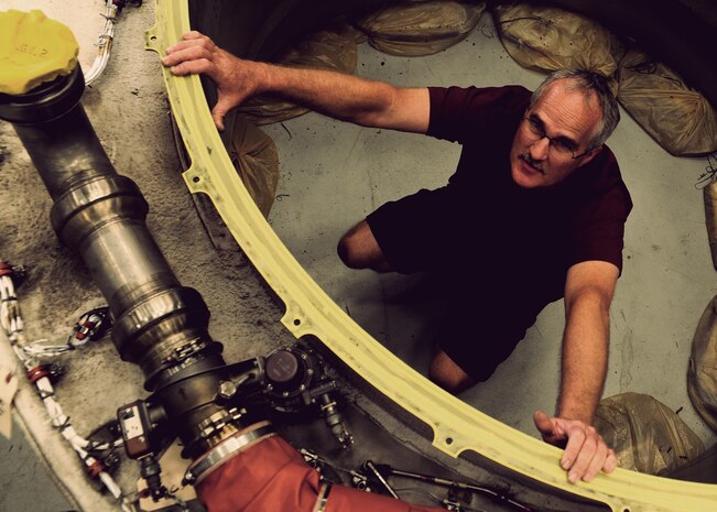 Corey Seeber stops for a photo in a C-17 Globemaster III engine inlet at the Joint Base Charleston – Air Base C-17 engine shop May 2. Seeber is an aviation maintenance technician with United Airlines. (U.S. Air Force photo/Staff Sergeant Katie Gieratz)