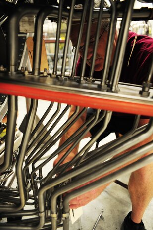 Corey Seeber repositions drain line clamps on a C-17 Globemaster III engine at the Joint Base Charleston – Air Base C-17 engine shop May 2. The all-civilian engine shop installs, inspects and repairs five to six engines a month. Seeber is an aviation maintenance technician with United Airlines. (U.S. Air Force photo/Staff Sergeant Katie Gieratz)