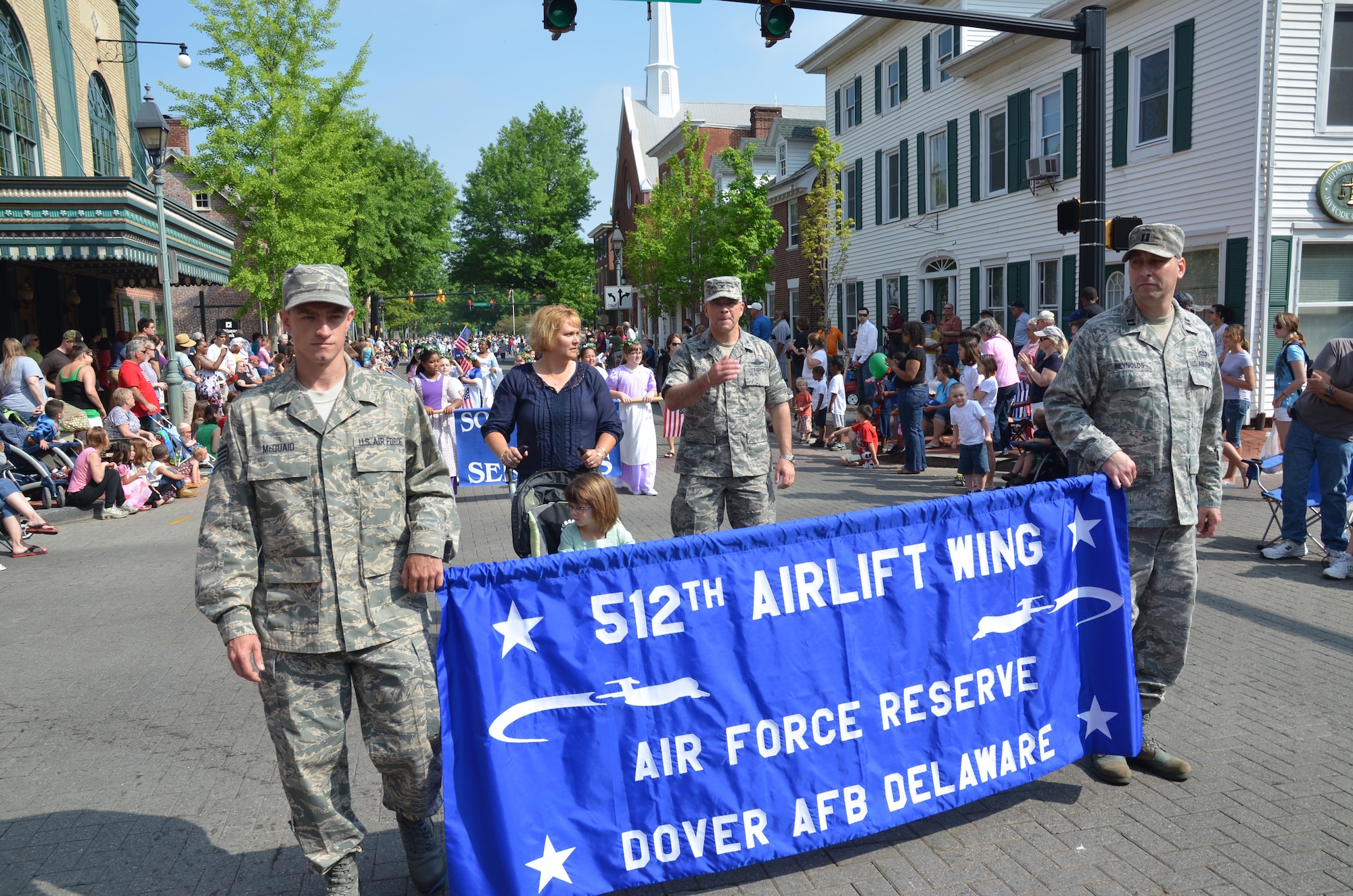Staff Sgt. Shawn McQuaid (left) and Capt. Jeremy Reynolds lead 512th Airlift Wing Commander Col. Randal L. Bright and his family along a parade route in downtown Dover, Del., May 5, 2012, during the annual Dover Days Festival.  The three-day event celebrated the diversity, traditions and talents of the residents of the city and its 329-year history. McQuaid is a fuels operations specialist with the 512th Logistics Readiness Squadron, while Reynolds is executive officer of the 512th Mission Support Group. They and Bright represented the reserve wing during the celebration, which was attended by more than 35,000 people.