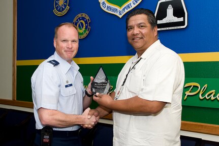 Carlos Mata, 359th Medical Group facility manager, receives the individual energy initiatives award from Col. Scott Peel,  902nd Mission Support Group commander, May 7 concluding a base-wide energy conservation competiton at Joint Base San Antonio-Randolph, Texas . (U.S. Air Force photo by Benjamin Faske)
