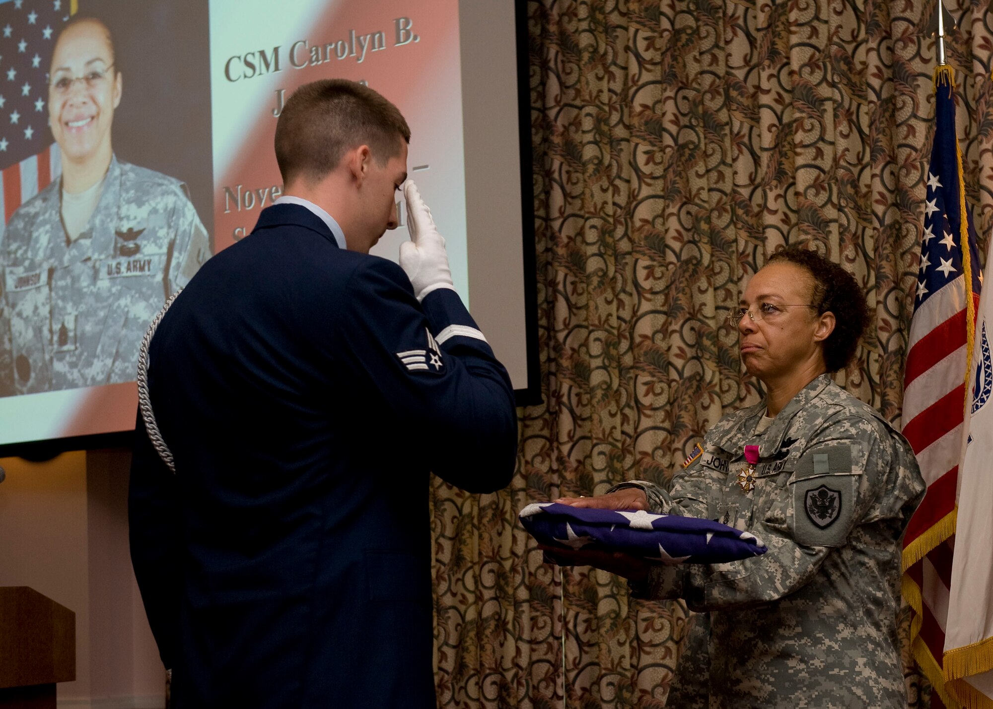 Command Sgt. Maj. Carolyn B. Johnson, right, 733rd Mission Support Division/Army Support Group Activity, receives the colors from the Langley Air Force Base Honor Guard during her retirement ceremony at Fort Eustis, Va., May 4, 2012. Johnson served more than 28 years in the U.S. Army in a variety of positions, including aircraft power plant and component repair supervisor, drill sergeant, first sergeant and command sergeant major. Her significant awards and decorations include the Bronze Star, Meritorious Service Medal, Army Commendation Medal and Army Achievement Medal. (U.S. Air Force photo by Senior Airman John D. Strong II/Released)
	
