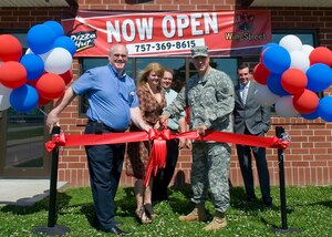 U.S. Army Col. Thomas Wetherington, 733rd Mission Support Division commander, cuts the ceremonial ribbon at the "grand opening" of the new Pizza Hut restaurant at Fort Eustis, Va., May 8, 2012. The restaurant opened its doors to customers May 1 at its location adjacent to the Eustis Community Recreation Center. (U.S. Air Force photo by Senior Airman John D. Strong II/Released)
