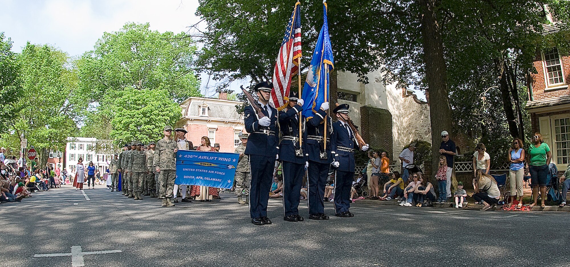 Honor Guard members from the 436th Airlift Wing at Dover Air Force Base, Del., march in front of Col. Mark Camerer, commander of the 436th AW, and a flight of service members at Old Dover Days in Dover, Del.  For the past 78 years, members in the Mid-Atlantic region adopt Dover, as their honorary state capital to celebrate the history and heritage of the first state. (U.S. Air Force photo by Senior Airman Jacob Morgan)