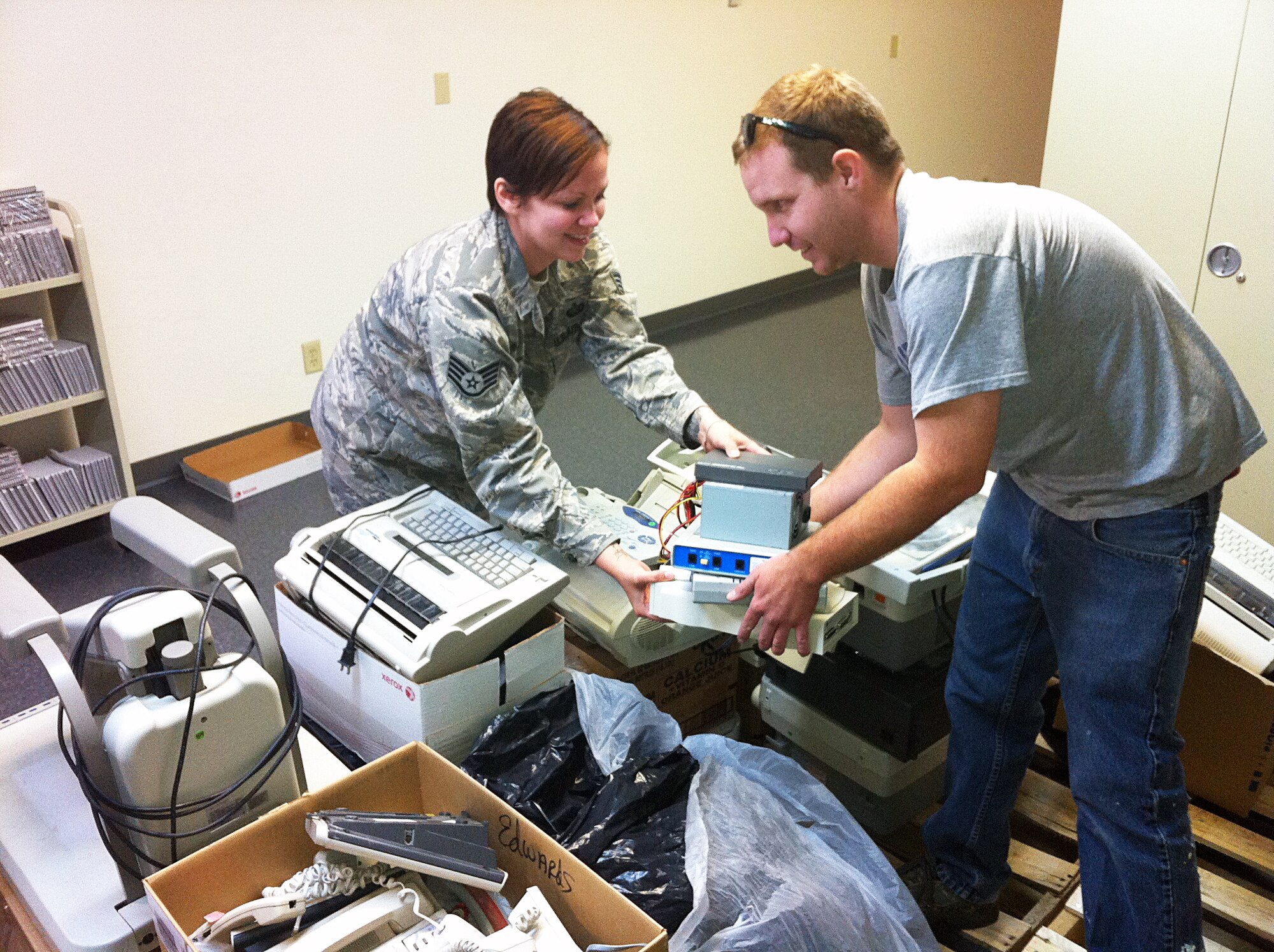 Staff Sgt. Leah Polhemus-Barron, 95th Force Support Squadron, collects old electronic devices at Bldg. 3738 during Spring Clean-up Week. The E-Waste Collection part of the week took in approximately 300 lbs of old electronic devices. (Courtesy photo)