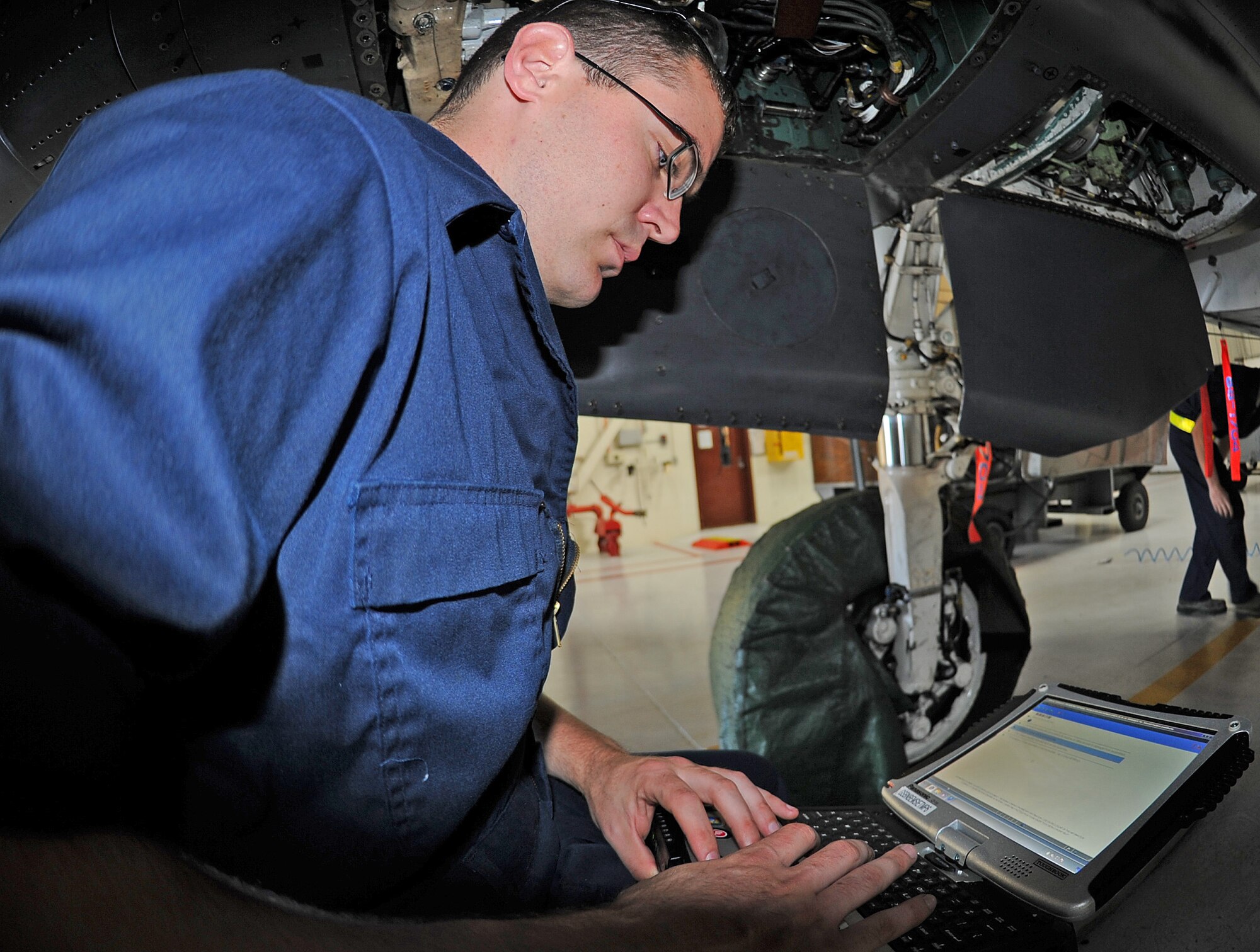 U.S. Air Force Airman 1st Class Jacob Neptune reviews a technical order prior to performing maintenance on an F-15E Strike Eagle on Seymour Johnson Air Force Base, N.C., May 7, 2012. The aircraft is undergoing an hourly post-phase inspection where every panel of the jet will be opened/removed, inspected and repaired. Neptune, 4th Equipment Maintenance Squadron crew chief, hails from Midland, Texas. (U.S. Air Force photo/Senior Airman Gino Reyes/Released)