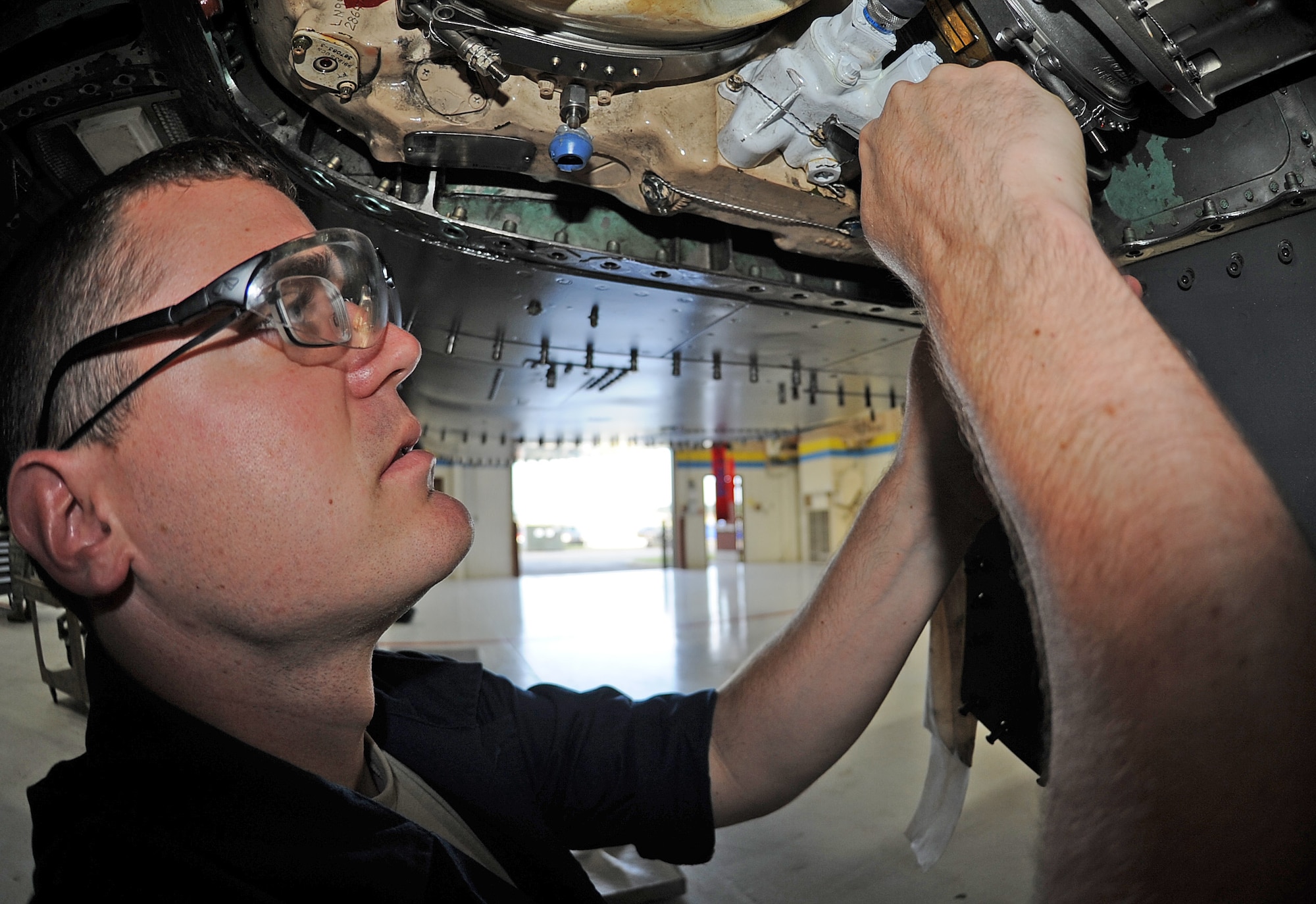 U.S. Air Force Airman 1st Class Jacob Neptune installs safety wire on an F-15E Strike Eagle during an hourly post-phase inspection on Seymour Johnson Air Force Base, N.C., May 7, 2012. The safety wire is installed to prevent bolts from loosening while the aircraft is in flight. Neptune, 4th Equipment Maintenance Squadron crew chief, hails from Midland, Texas. (U.S. Air Force photo/Senior Airman Gino Reyes/Released)