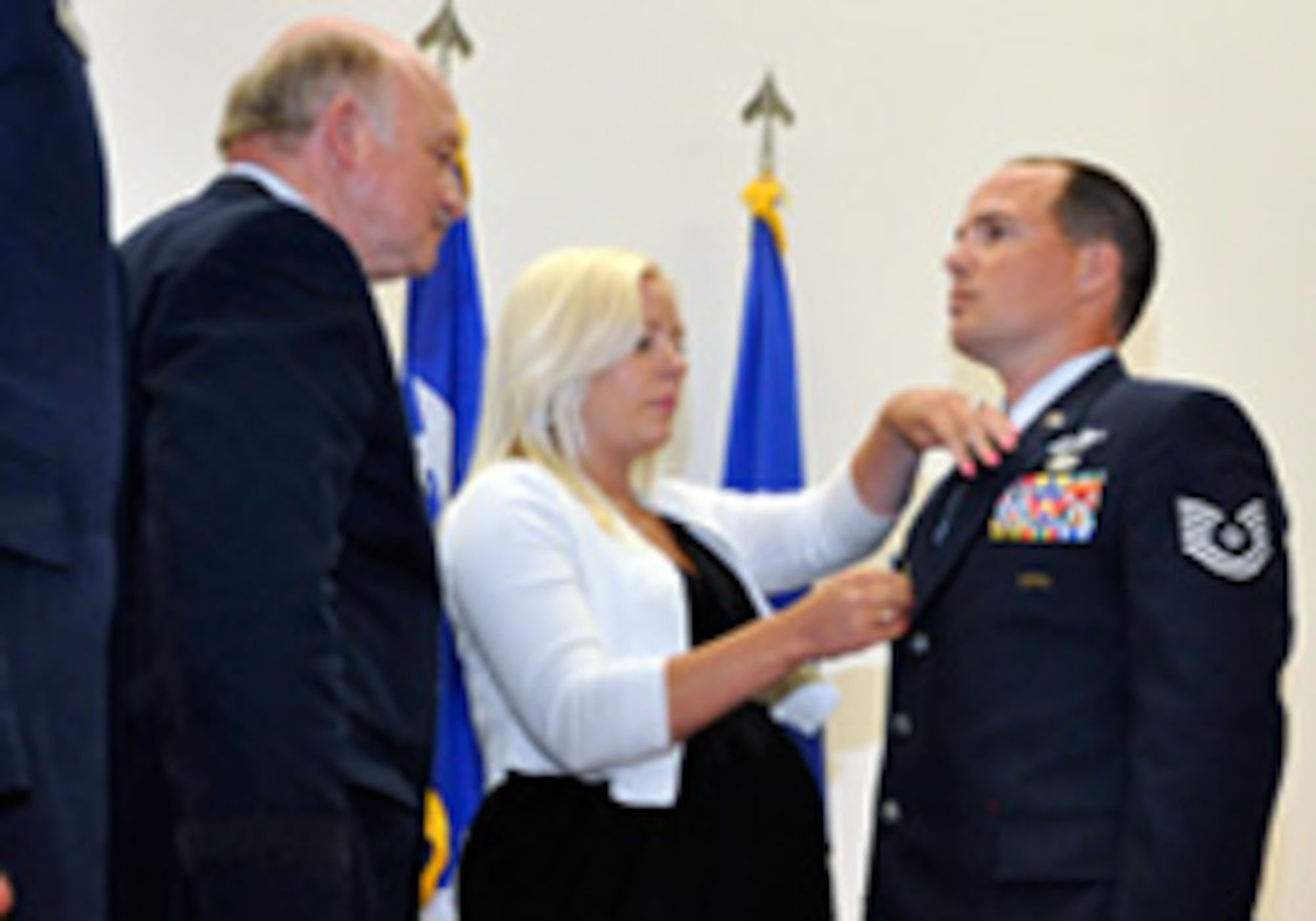 Tech. Sgt. Tavis J. Delaney, with the Washington Air National Guard’s 116th Air Support Operations Squadron, stands at attention as his wife Courtney pins the Silver Star medal to his uniform during a presentation ceremony at Joint Base Lewis-McChord, Wash,, May 6, 2012. Delaney received the award—the nation's third highest award for valor in action—for actions in combat during his 2011 deployment to Afghanistan with the squadron. (Photo by Staff Sgt. Stephen C. Mattson)
