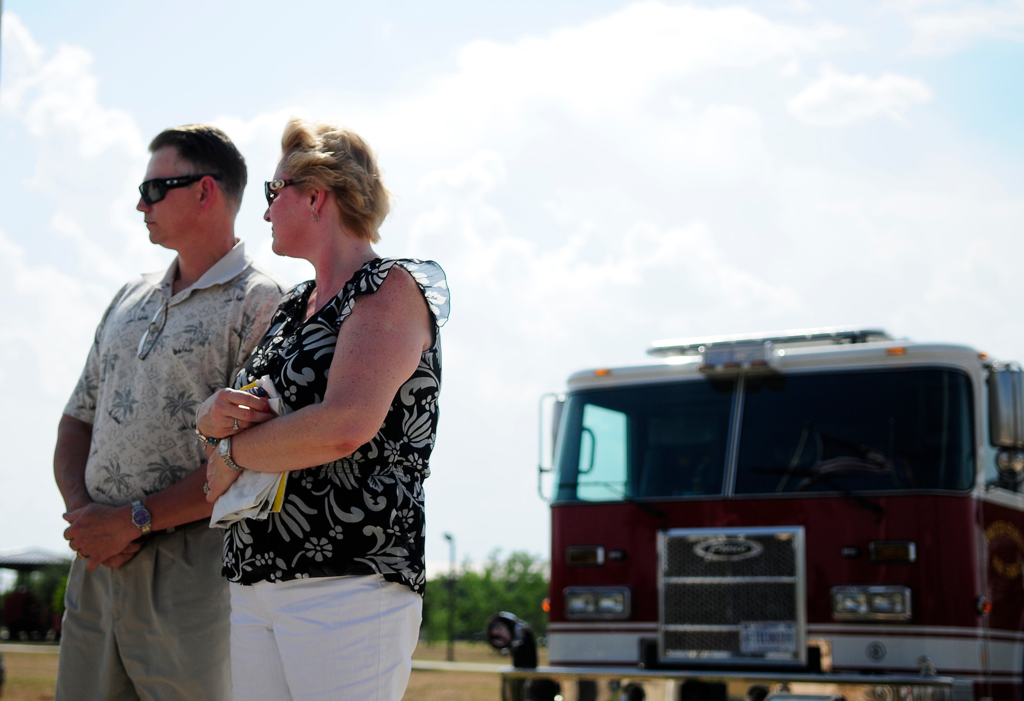 GOODFELLOW AIR FORCE BASE, Texas – Family members of a fallen firefighter take a moment to reflect, after receiving the Department of Defense Fire Emergency Services Flag. The annual DOD Fallen Firefighter Memorial Ceremony was held May 4. (U.S. Air Force photo/Staff Sgt. Austin Knox)   