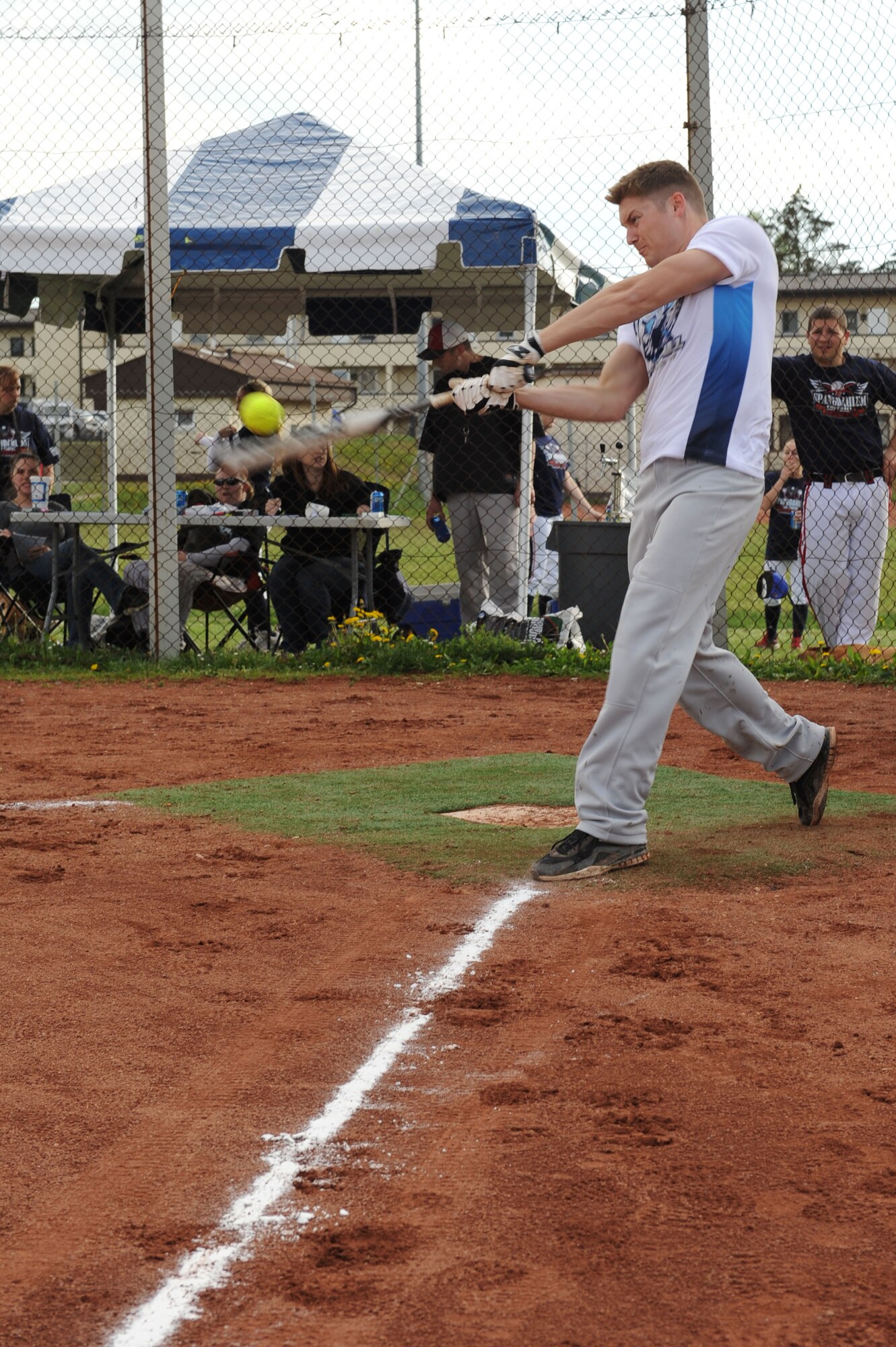 SPANGDAHLEM AIR BASE, Germany – Broderick Morris, 52nd Logistics Readiness Squadron member and substitute player for Royal Air Force Lakenheath, England, hits a ball during a double elimination Cinco de Mayo softball tournament here May 4. The RAF Lakenheath team beat the Aviano AB, Italy, team with a final score of 16 - 6 in the first game of the tournament. The varsity Sabers softball teams hosted the event to raise funds for future tournaments. Ramstein AB took first place overall by beating another team from Ramstein with a score of 36 - 25.  (U.S. Air Force photo by Senior Airman Christopher Toon/Released)