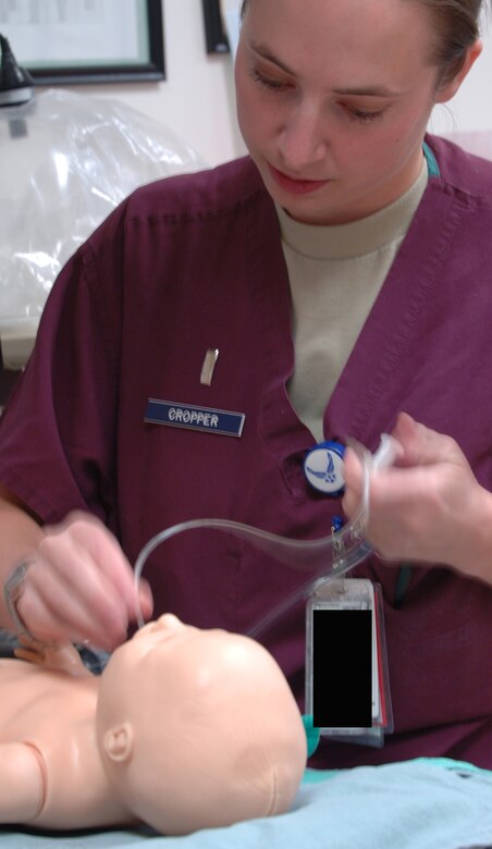 U.S. Air Force 1st Lt. Jacqueline Cropper, 366th Medical Group obstetrical nurse, simulates a medical procedure on a doll during a training exercise, May 1, 2012, at Mountain Home Air Force Base, Idaho. Cropper and other members of the night-shift at the Family Care Unit support the Urgent Care Center whenever needed. (U.S. Air Force photo/Airman 1st Class Shane M. Phipps)