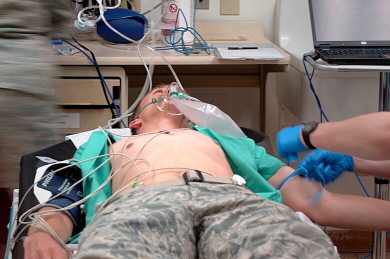 U.S. Air Force Staff Sgt. Michael Sibbet, 366th Medical Group technician, acts as an urgent care patient suffering from multiple ailments during a training exercise May 1, 2012, at Mountain Home Air Force Base, Idaho. The technicians manning the Urgent Care Center are expected to adequately execute a variety of duties their civilian counterparts cannot. (U.S. Air Force photo/Airman 1st Class Shane M. Phipps)