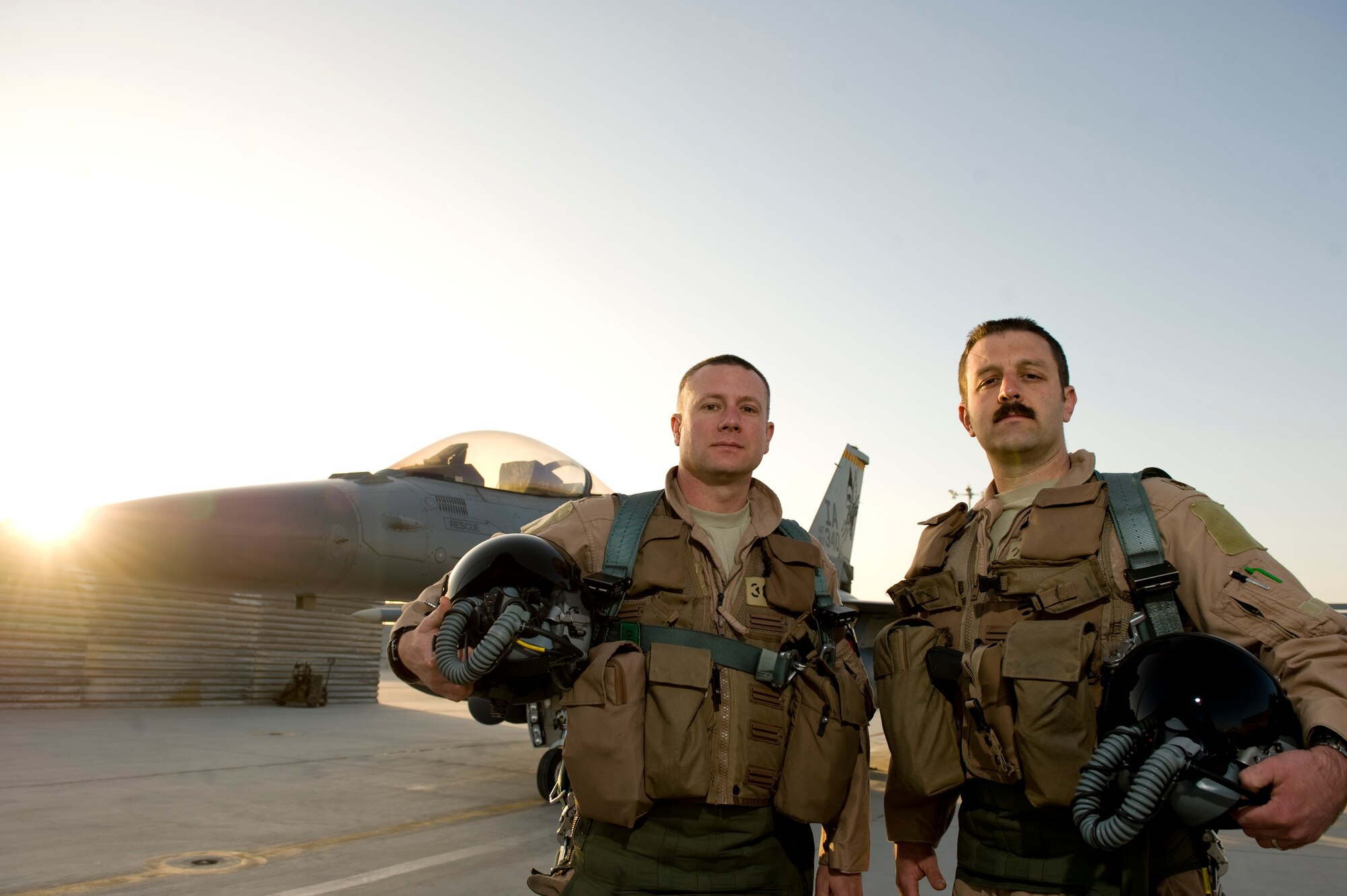 U.S. Air Force Maj. Chad Lewis and  Maj. Greg Barasch from Des Moines, Iowa are F-16C pilots with the 451st Expeditionary Fighter Squadron. The mission of the 451st EFS is to deliver decisive airpower on target, on time. (U.S. Air Force photo/Staff Sgt. Greg Biondo)
