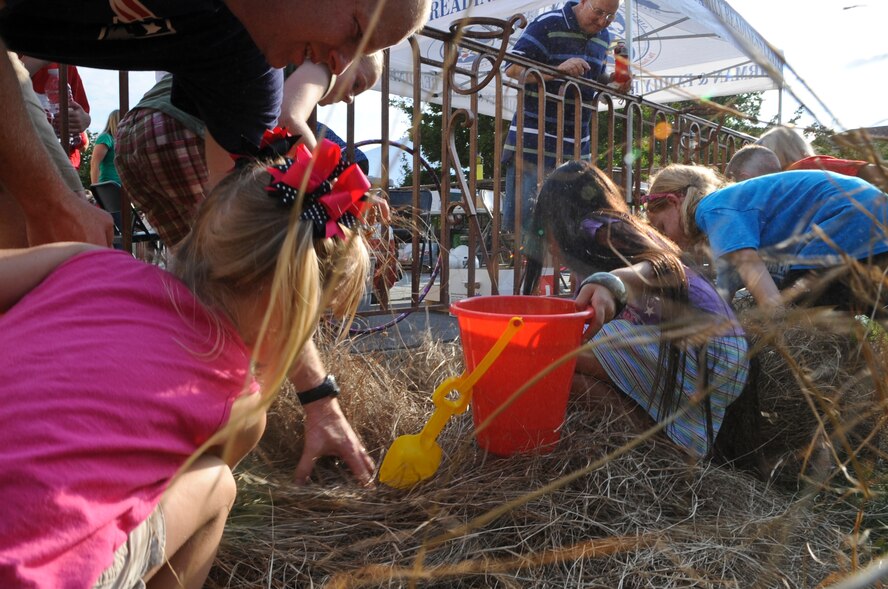Children dig through hay during a crawfish hunt at the 2012 Crawfish Festival on Barksdale Air Force Base, La., May 4. Along with the crawfish hunt, the Airmen and Family Readiness Center hosted several events for children to participate in for a chance to win prizes. (U.S. Air Force photo/Airman 1st Class Micaiah Anthony)(RELEASED)