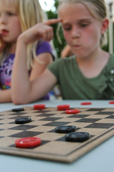 Natalea Rice, 10, thinks about her next move during a checkers competition at the 2012 Crawfish Festival on Barksdale Air Force Base, La., May 4. During the festival, the Airmen and Family Readiness Center hosted a jump rope competition, crawfish hunt, hula hoop contest, zydeco dance and a crawfish eating contest for the children in attendance. (U.S. Air Force photo/Airman 1st Class Micaiah Anthony)(RELEASED)