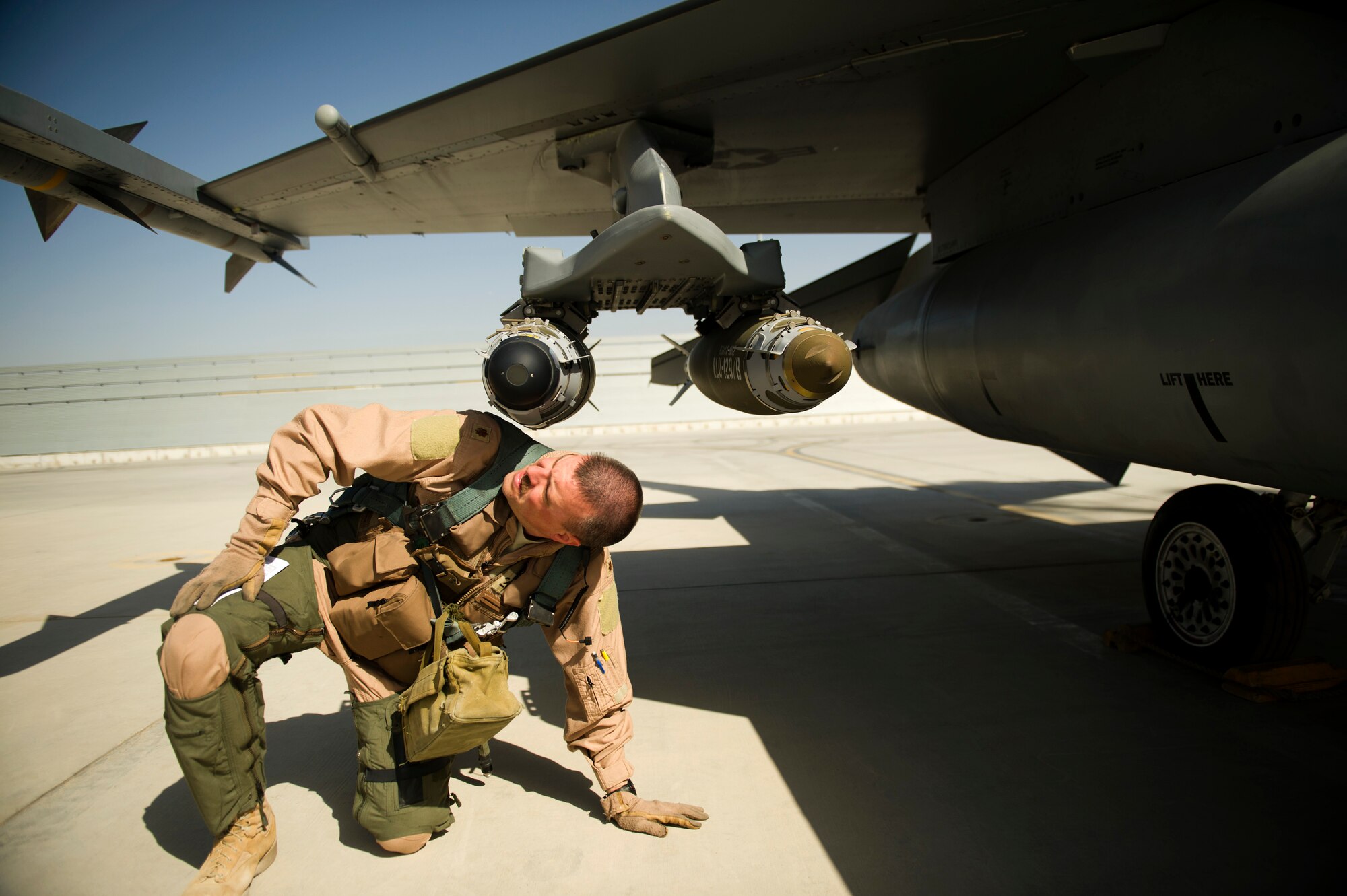 U.S. Air Force Maj. Todd Pierce, a pilot with the 451st Expeditionary Fighter Squadron and native of Norwalk, Iowa, inspects the bombs and missiles on an F-16C Fighting Falcon, April 5, 2012, at Kandahar Airfield, Afghanistan. The mission of the 451st EFS is to deliver decisive airpower on target, on time.