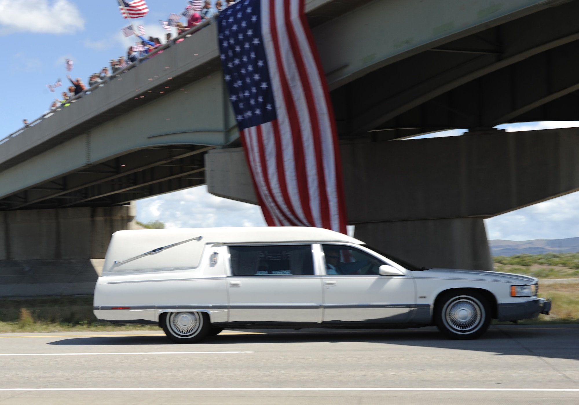 A hearse carrying the late U.S. Army Sgt. Chris Workman, with the 2nd Battalion, 25th Aviation Regiment, 25th Infantry Division from Wheeler Army Airfield, Hawaii, drives through Mountain Home, Idaho, May 2, 2012 on Interstate 84. Workman lost his life when the UH-60 Black Hawk he was in went down while supporting Overseas Contingency Operations. (U.S. Air Force photo/ Airman 1st Class Jonathan Glanville)