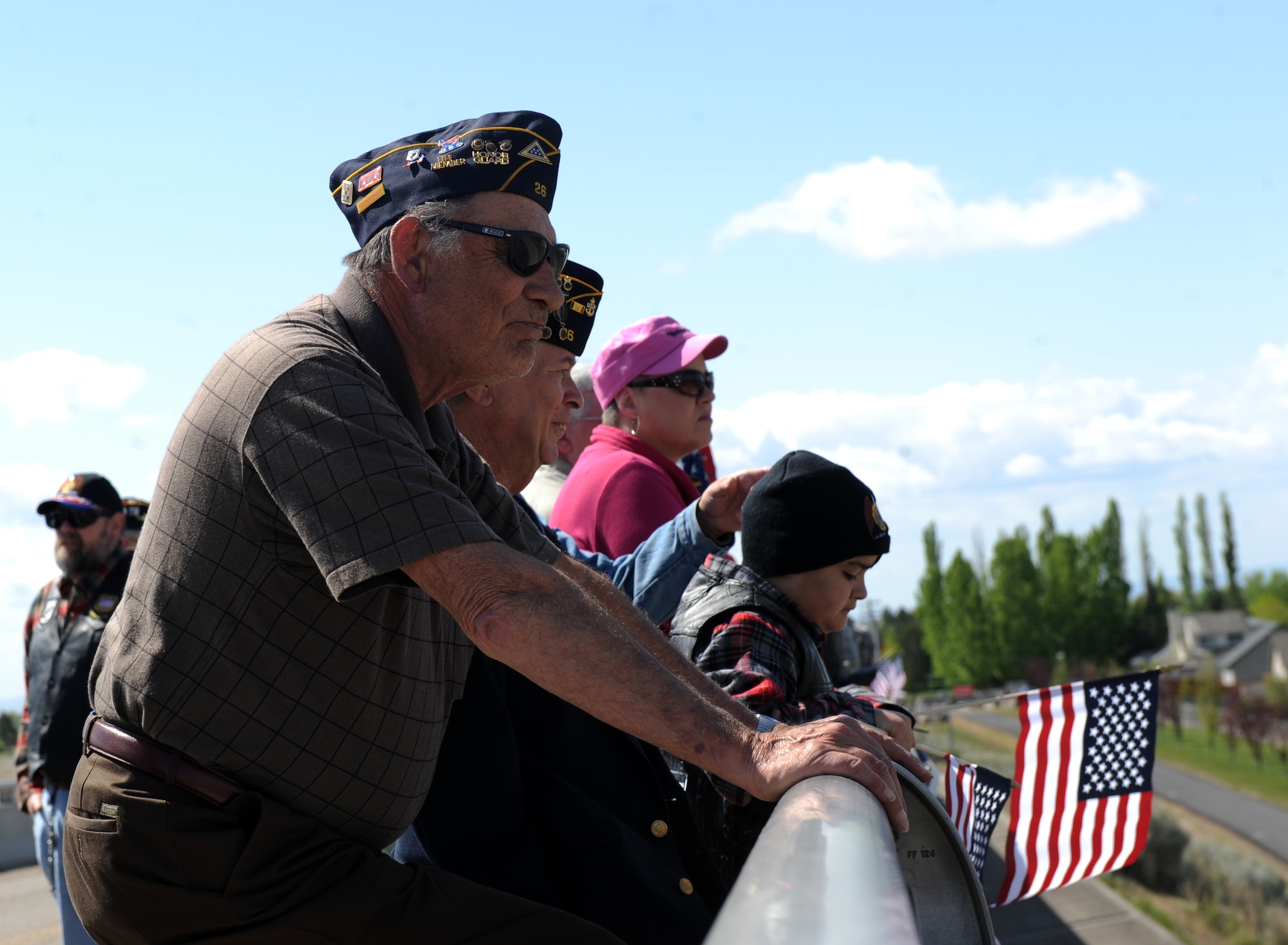 Retired U.S. Air Force Master Sgt. Jim Metzer awaits the arrival of a hearse that carried the late Army Sgt. Chris Workman, who was part of the 2nd Battalion, 25th Aviation Regiment, 25th Infantry Division based out of Wheeler Army Airfield, Hawaii, as it passes through Mountain Home, Idaho. Metzer, along with 130 other people, came out to show respect to the fallen hero. (U.S. Air Force photo/ Airman 1st Class Jonathan Glanville)