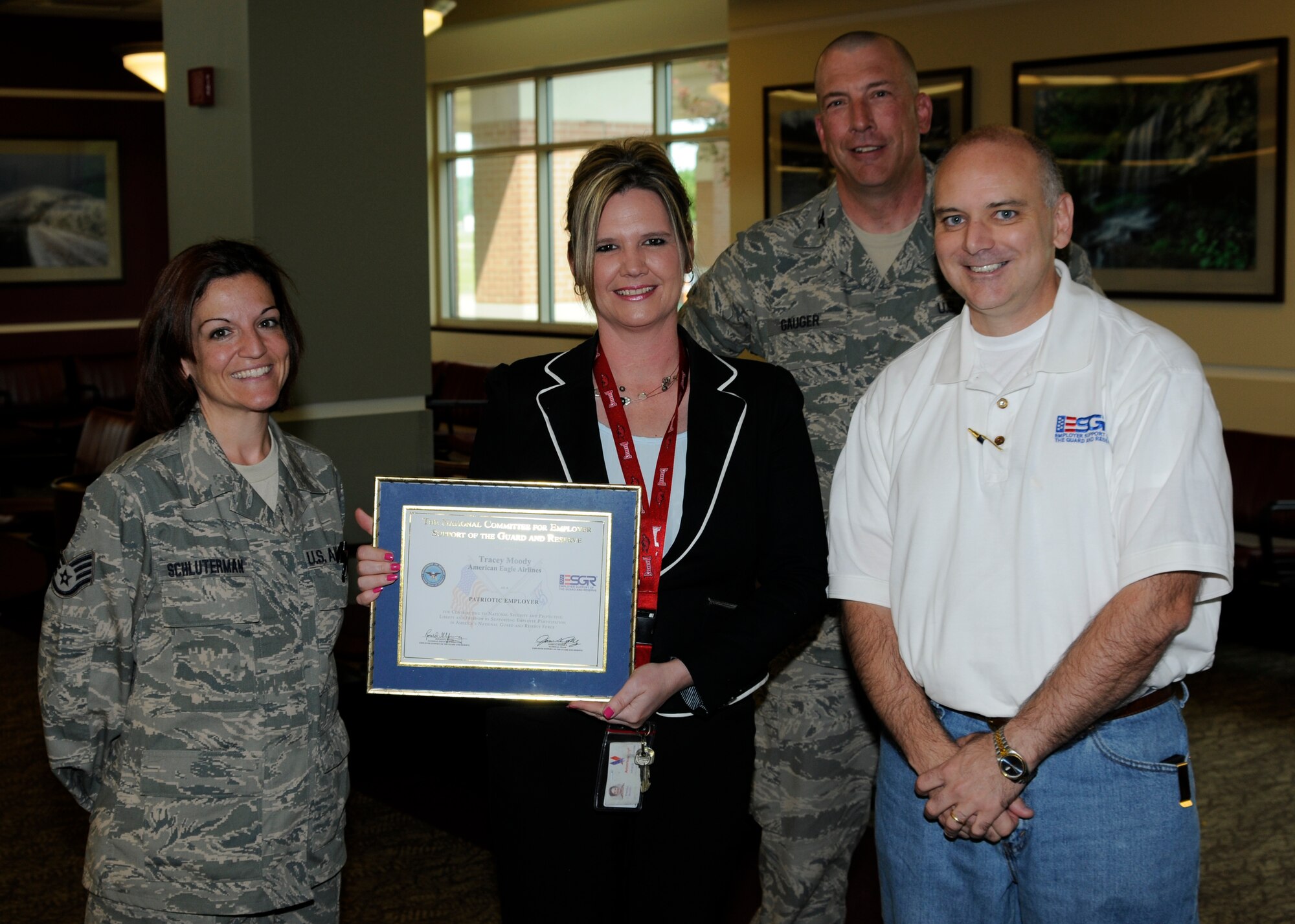 From left: Staff Sgt. Shilo Schluterman, a member of the 188th Aircraft Maintenance Squadron and American Eagle Airlines employee; Tracey Moody with American Eagle Airlines; Col. Pete Gauger, 188th Fighter Wing vice commander; and Jon Woodham, employer relations specialist with the Arkansas Committee for Employer Support of the Guard and Reserve. Moody, Schluterman’s civilian supervisor, was presented a Patriot Award for being highly supportive of Schluterman’s career in the Arkansas Air National Guard’s 188th Fighter Wing. (National Guard photo by Senior Master Sgt. Dennis Brambl/188th Fighter Wing Public Affairs)