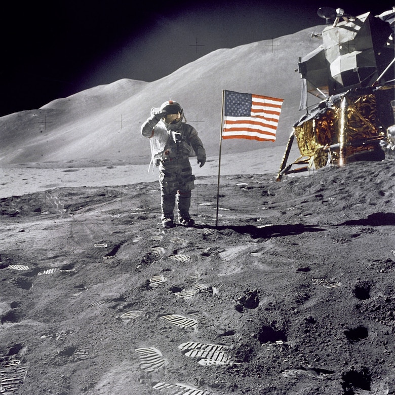 Apollo 15 Commander Dave Scott salutes the American flag at the Hadley-Apennine lunar landing site. The Lunar Module "Falcon" is partially visible on the right. (Photo courtesy of NASA)