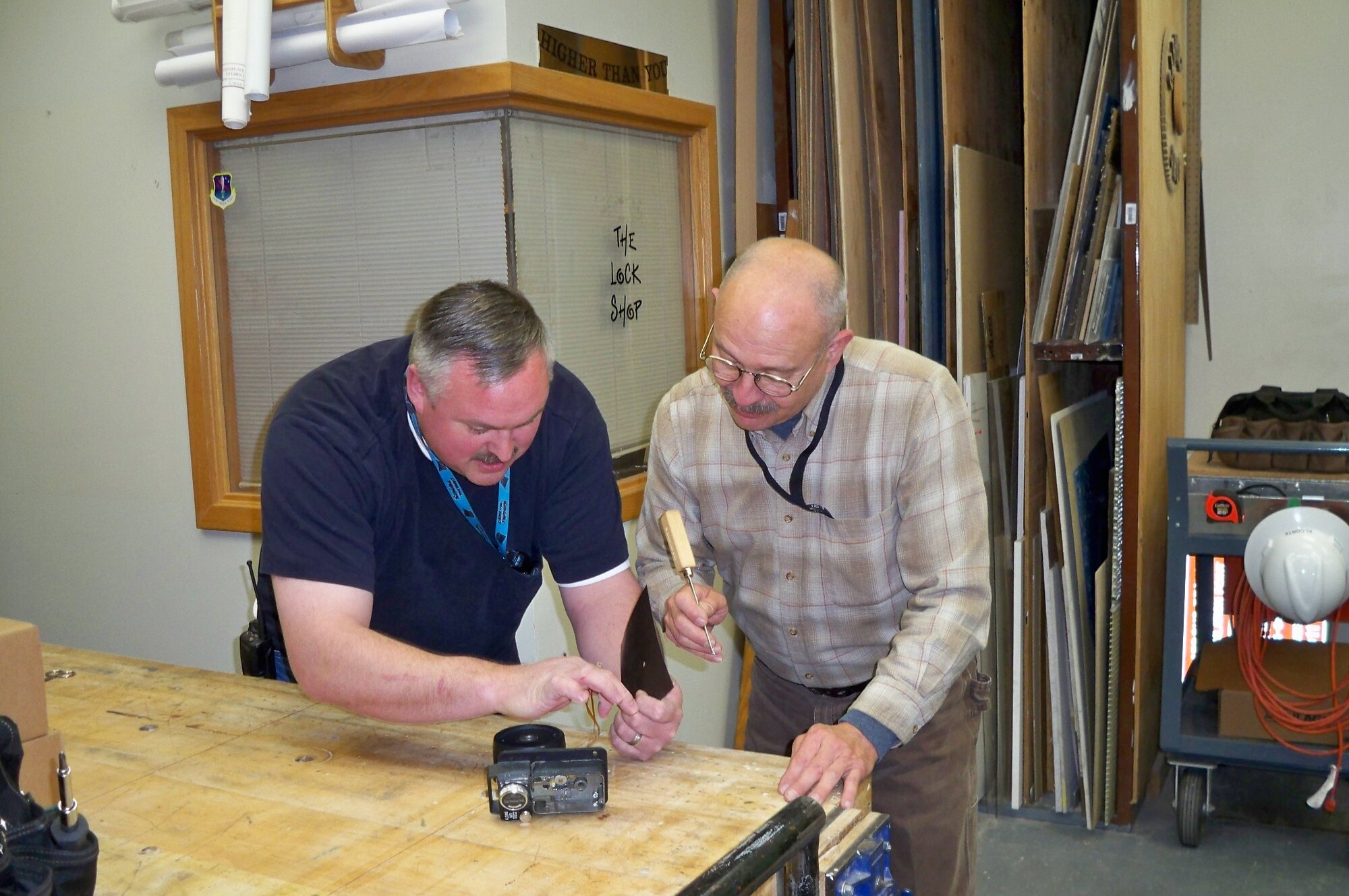 Scott Hamilton and Mike Alcorta, certified container inspectors at the 721st CED, inspect, install and repair all manner of security container locks, saving the wing thousands of dollars per year. (U.S. Air Force photo)