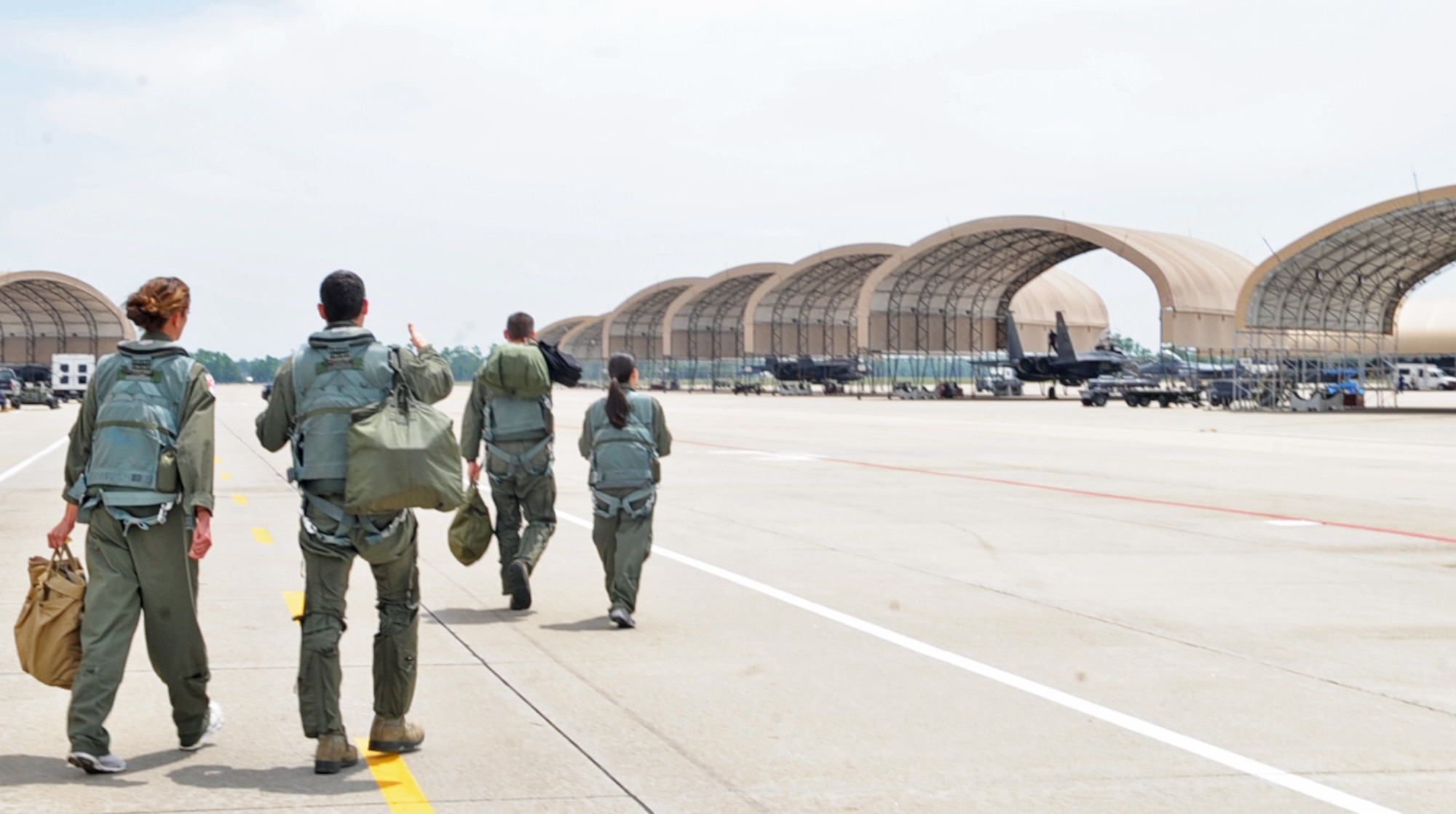 U.S. Air Force Airmen and spouses step to their F-15E Strike Eagles for an incentive taxi ride on Seymour Johnson Air Force Base, N.C., May 4, 2012. It is so rare for spouses to have an incentive taxi-ride that many of them waited more than 15 years before they were given this opportunity. (U.S. Air Force photo/Airman 1st Class Aubrey Robinson/Released)