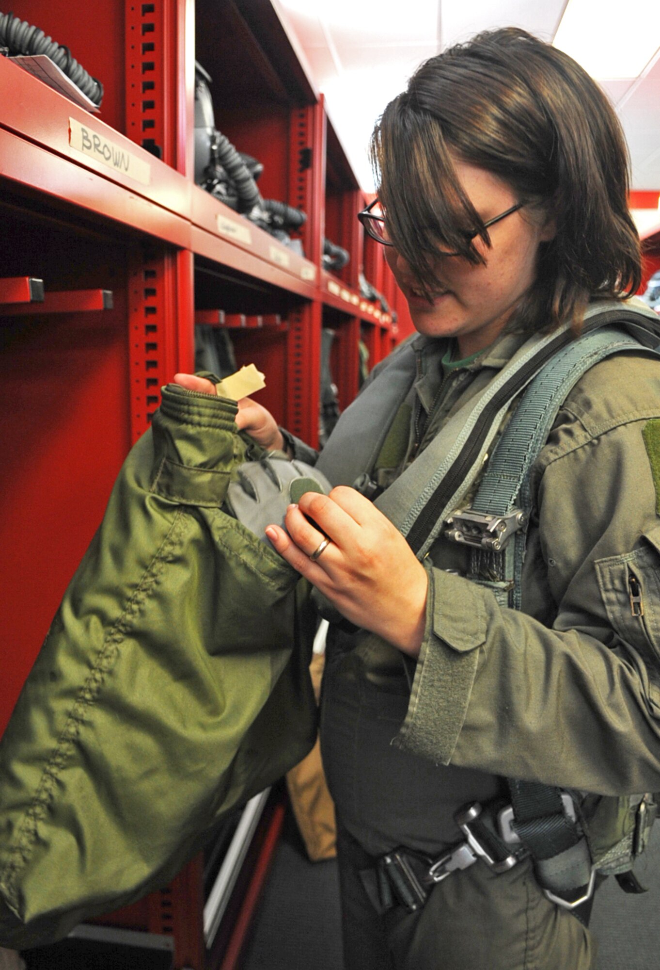 Starr Brown inspects the contents of her flight bag prior to an F-15E Strike Eagle taxi ride on Seymour Johnson Air Force Base, N.C., May 4, 2012. Gear necessary for taxi rides and flights, such as helmets and gloves, are kept together in a flight bag to prevent their loss. Brown is the wife of Senior Airman Chase Brown, 333rd Aircraft Maintenance Unit crew chief, and hails from Fort Madison, Iowa. (U.S. Air Force photo/Airman 1st Class Aubrey Robinson/Released)