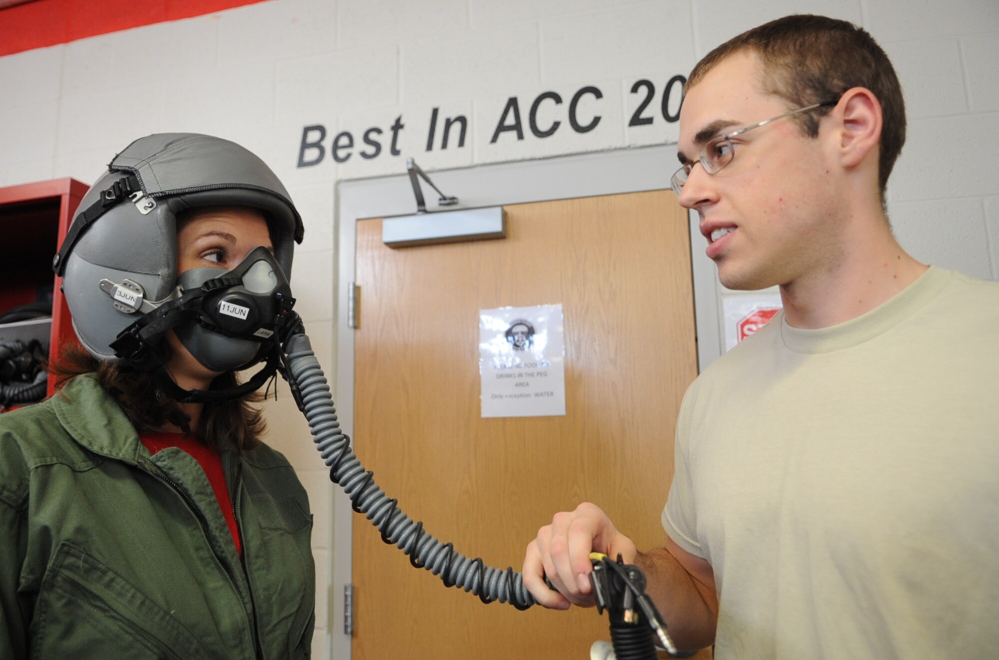 U.S. Air Force Staff Sgt. Dain Boelter tests Natalie Sisler’s oxygen mask prior to an F-15E Strike Eagle taxi ride on Seymour Johnson Air Force Base, N.C., May 4, 2012. Boelter tests aircrew member’s oxygen masks prior to a flight to make certain there are no air leaks or communication errors. Boelter, 4th Operations Support Squadron aircrew flight equipment journeyman, hails from Mendota Heights, Minn. Sisler is the spouse of U.S. Air Force Capt. Andrew Sisler a 333rd Fighter Squadron weapons systems officer from Garland, Texas. (U.S. Air Force photo/Airman 1st Class Aubrey Robinson/Released)
