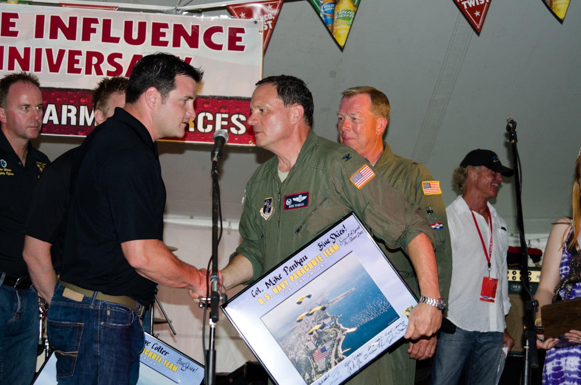 John Klatt, an aerobatics pilot for the Air National Guard, presents Lt. Col. Byron Newell, the Sound of Speed Airshow coordinator, with a photo May 4, 2012 in St. Joseph, Mo. (Photo by Staff Sgt. Michael Crane/Missouri Air National Guard)