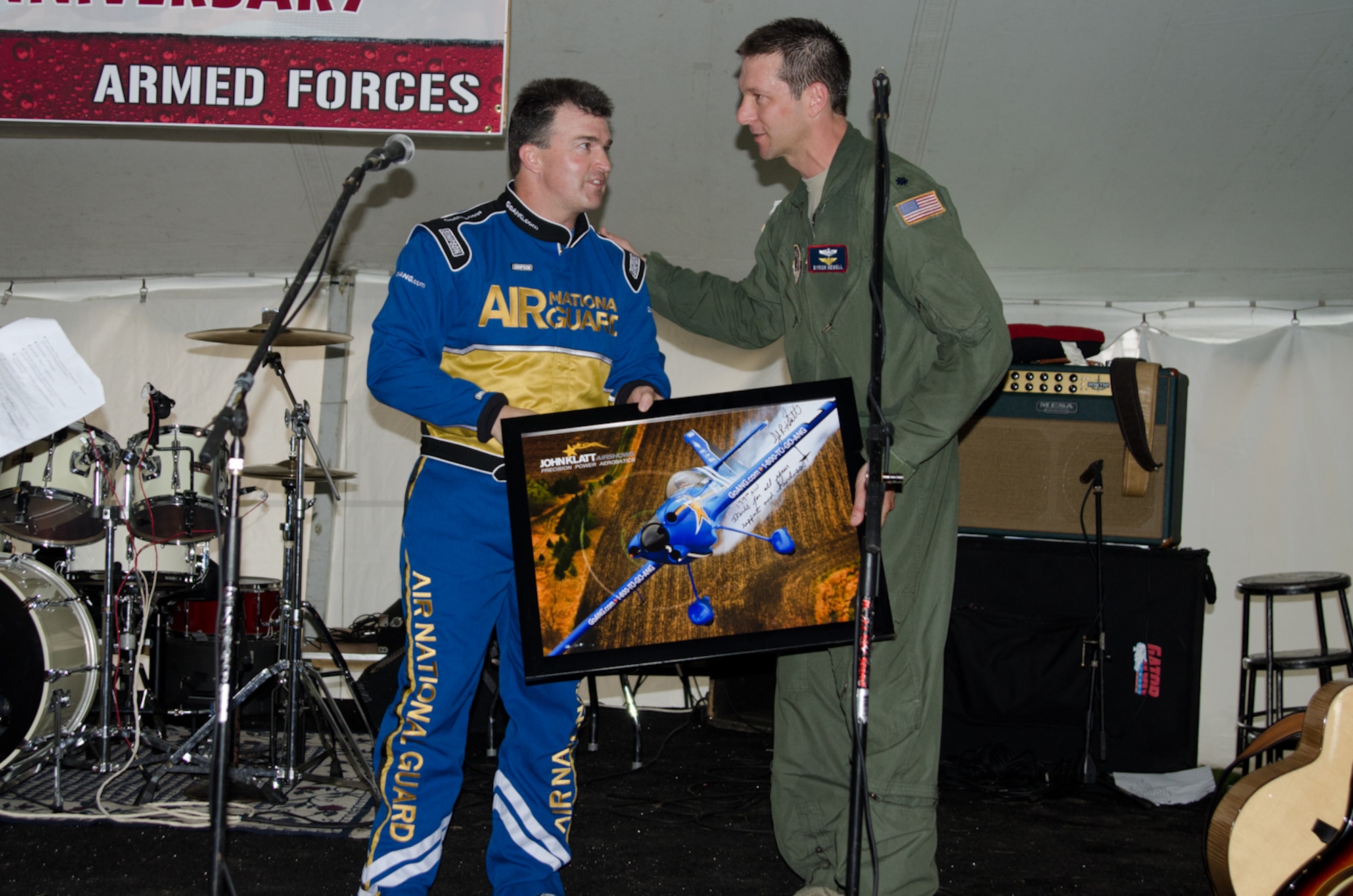 John Klatt, an aerobatics pilot for the Air National Guard, presents Lt. Col. Byron Newell, the Sound of Speed Airshow coordinator, with a photo May 4, 2012 in St. Joseph, Mo. (Photo by Staff Sgt. Michael Crane/Missouri Air National Guard)