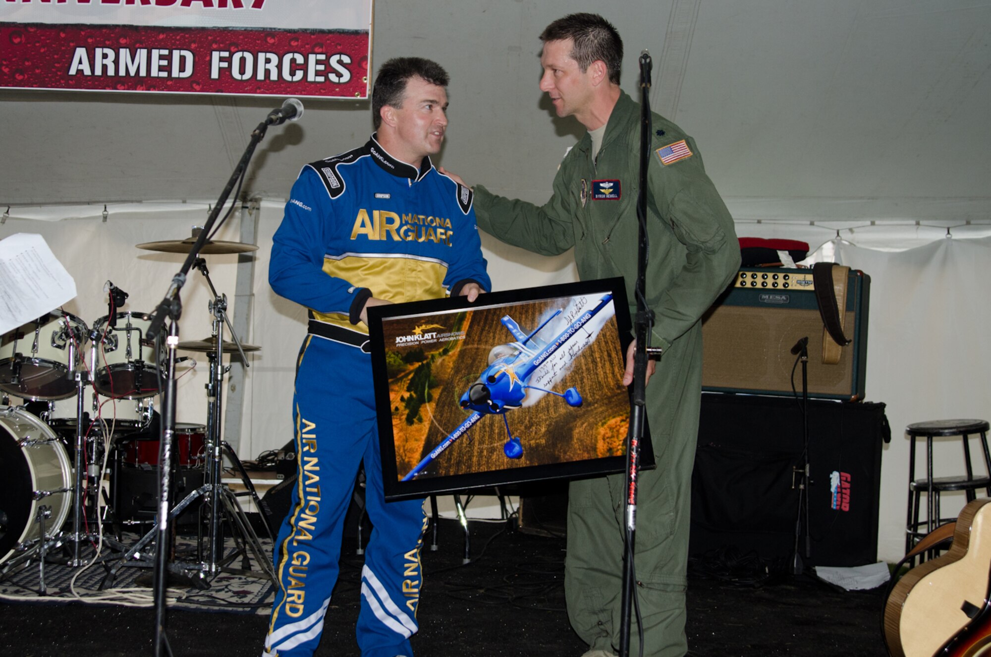 John Klatt, an aerobatics pilot for the Air National Guard, presents Lt. Col. Byron Newell, the Sound of Speed Airshow coordinator, with a photo May 4, 2012 in St. Joseph, Mo. (Photo by Staff Sgt. Michael Crane/Missouri Air National Guard)