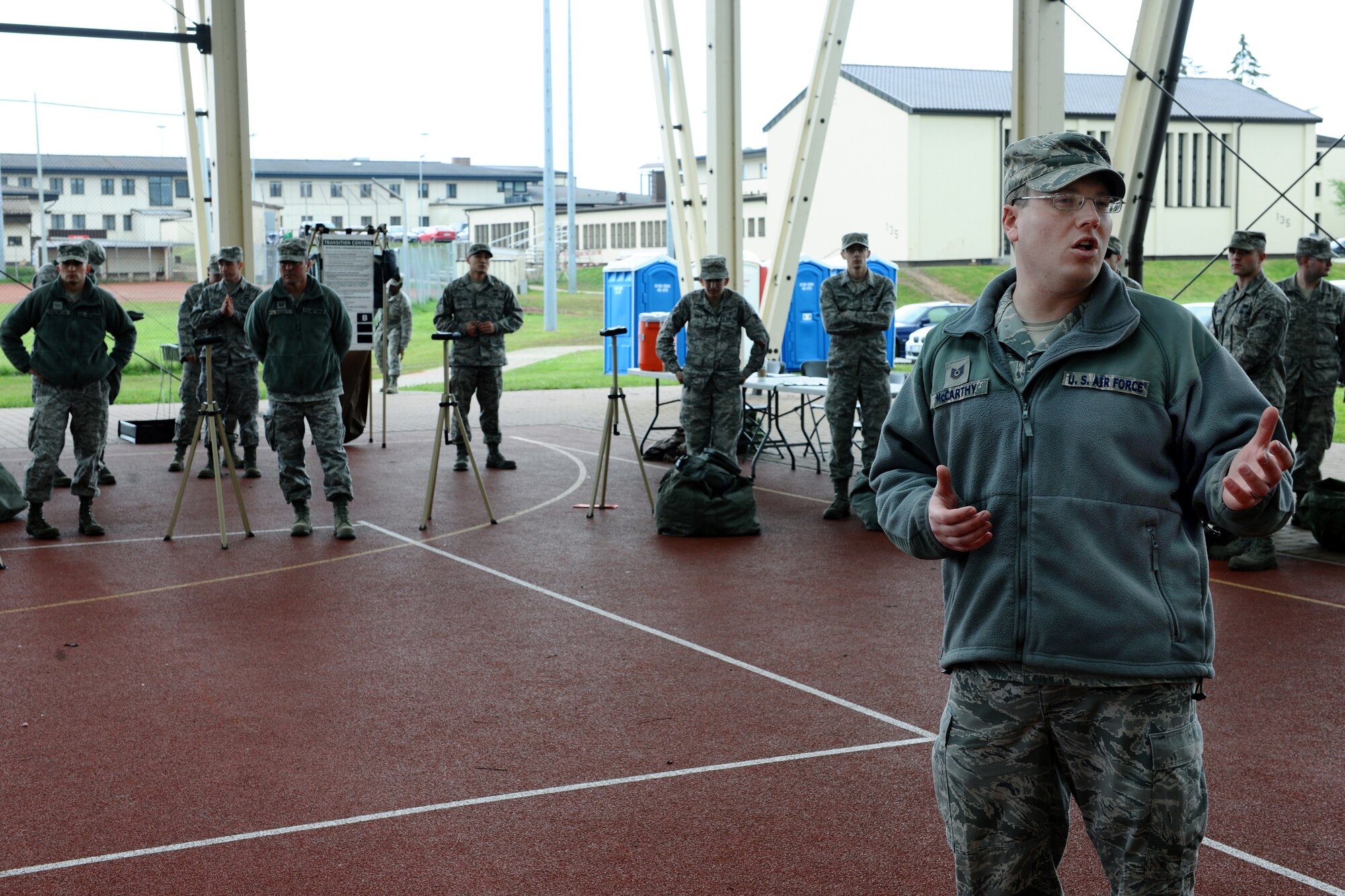 SPANGDAHLEM AIR BASE, Germany – Tech. Sgt. Conor McCarthy, 52nd Civil Engineer Squadron emergency management craftsmen, briefs Airmen before individual core competency skills training begins at the outdoor basketball court here May 7. The training evaluated Airmen on their combat readiness skills such as M-4 assault rifle weapons knowledge; self-aid buddy care; and chemical, biological, radiological, nuclear, and high-yield explosive preparedness. The training ensures the 52nd Fighter Wing is able to provide combat power to the current fight. (U.S. Air Force photo by Airman 1st Class Dillon Davis/Released)