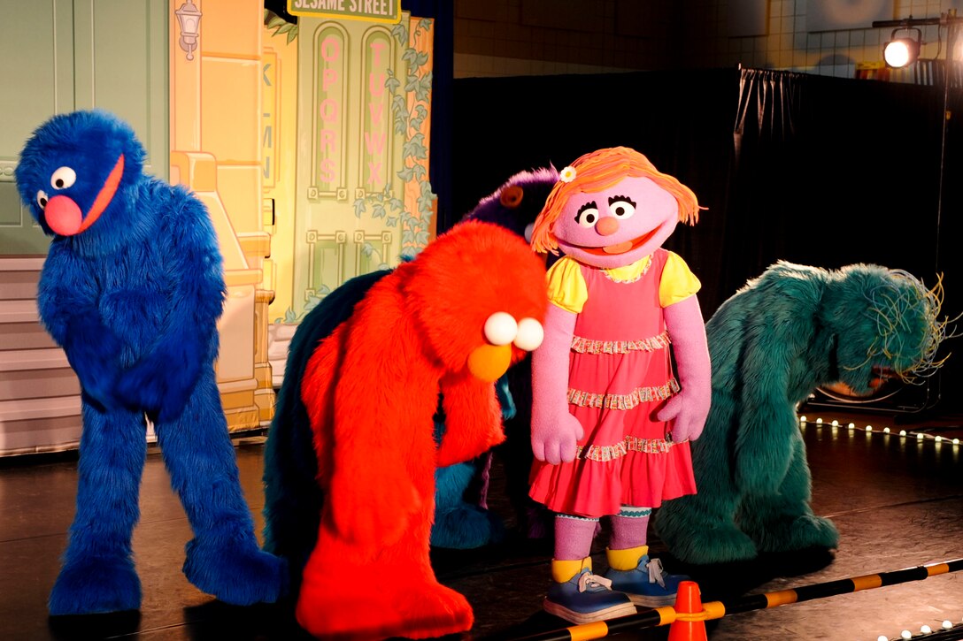 Sesame Street characters perform a skit where Katie, the character wearing the dress, discovers her family just got orders to a new base, during the 2011 Joining Forces: Sesame Street and USO Special Event show at the Langley Air Force Base, Va., youth center, May 7, 2012. The show dealt with many popular military family topics, including deployments and permanent change of station assignments. (U.S. Air Force photo by Senior Airman Wesley Farnsworth/Released)