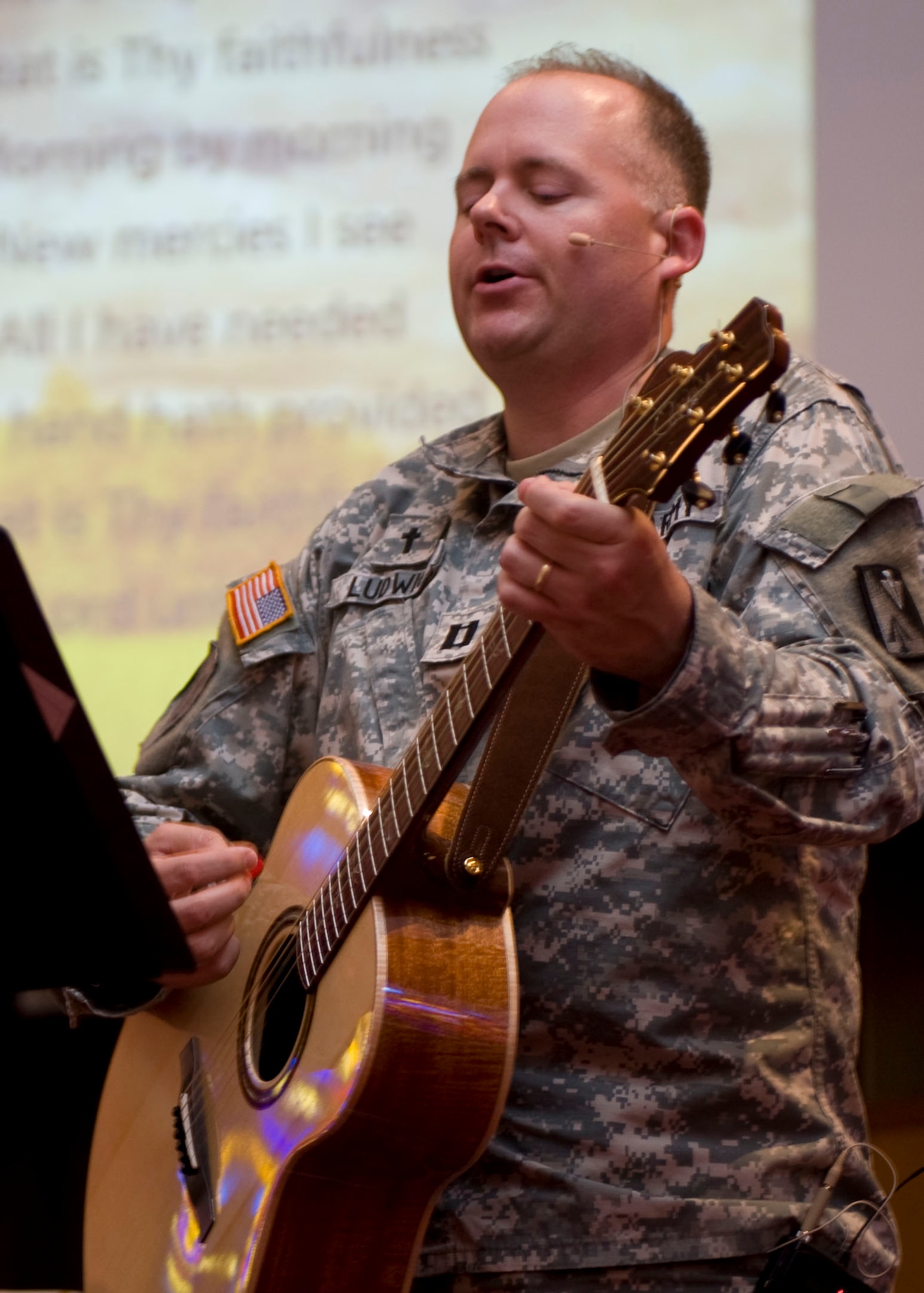 U.S. Army Chap. (Capt.) Craig Ludwig, 633rd Air Base Wing chaplain, plays his guitar and sings “Great is thy Faithfulness” during the National Day of Prayer celebration at the Regimental Memorial Chapel at Fort Eustis, Va., May 3, 2012. U.S. Army Chap. (Col.) Kenneth Bush, 633rd ABW deputy chaplain, said the event “is a reminder for us not to do this once a year, but to gather together and encourage each other to do it throughout the year.” (U.S. Air Force photo by Senior Airman John D. Strong II/Released) 